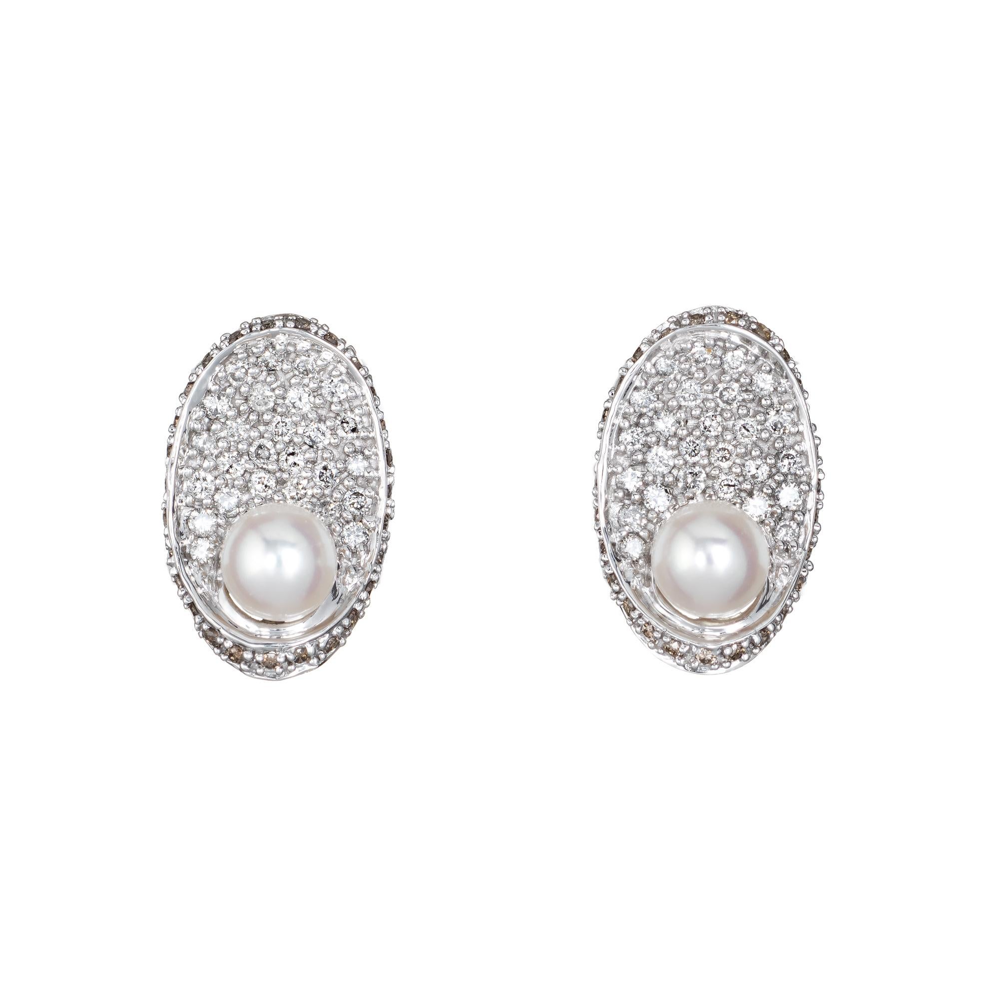 Elegant pair of pave diamond & cultured pearl earrings crafted in 14k white gold. 

Round brilliant cut diamonds total an estimated 0.84 carats (estimated at H-M color and VS2-SI1 clarity). Two 5.5mm cultured pearls accent the diamonds.  

The