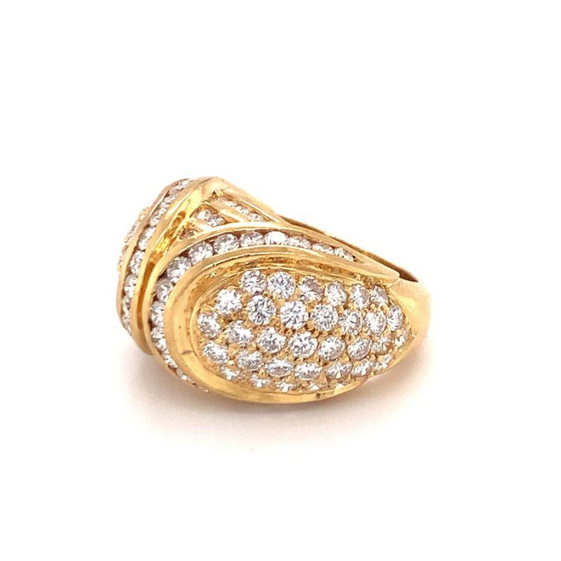 One diamond dome 18K yellow gold ring enhanced by 122 pave set, round brilliant cut diamonds totaling 4.15 ct. Circa 1970s.

Grand, lively, shimmering.

Additional information:
Metal: 18K yellow gold
Gemstone: Diamonds totaling 4.15 ct., G-H /