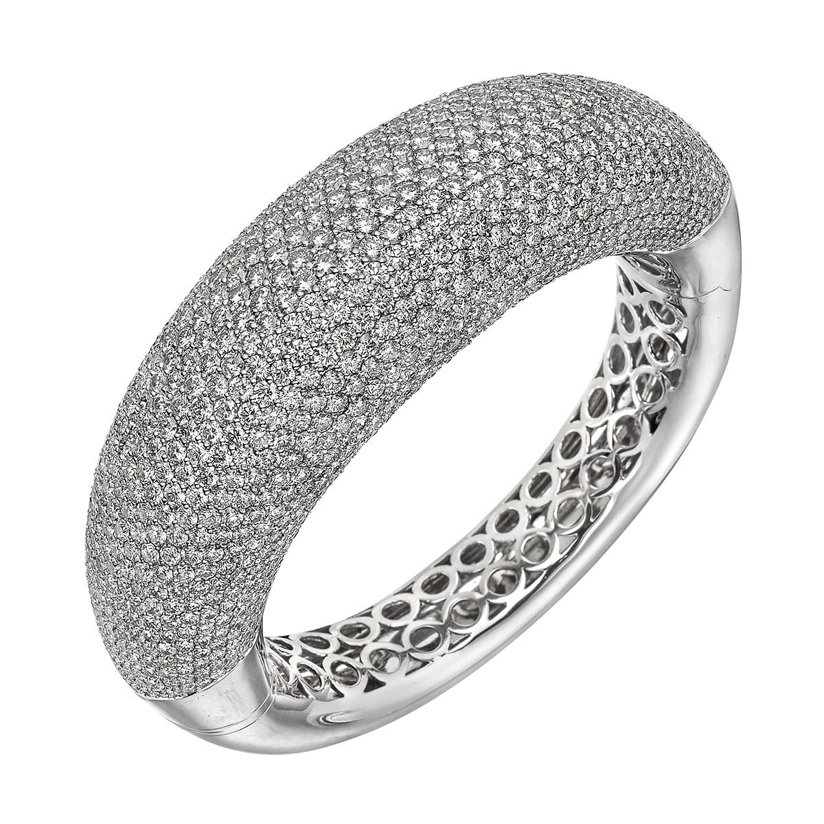 Oval-shaped domed wide bangle bracelet, featuring five rows of pavé round brilliant-cut diamonds set halfway around the bangle, in polished 18k white gold.

961 diamonds weighing ~40.00 total carats (F-G color, VVS-VS clarity)
Hinged with