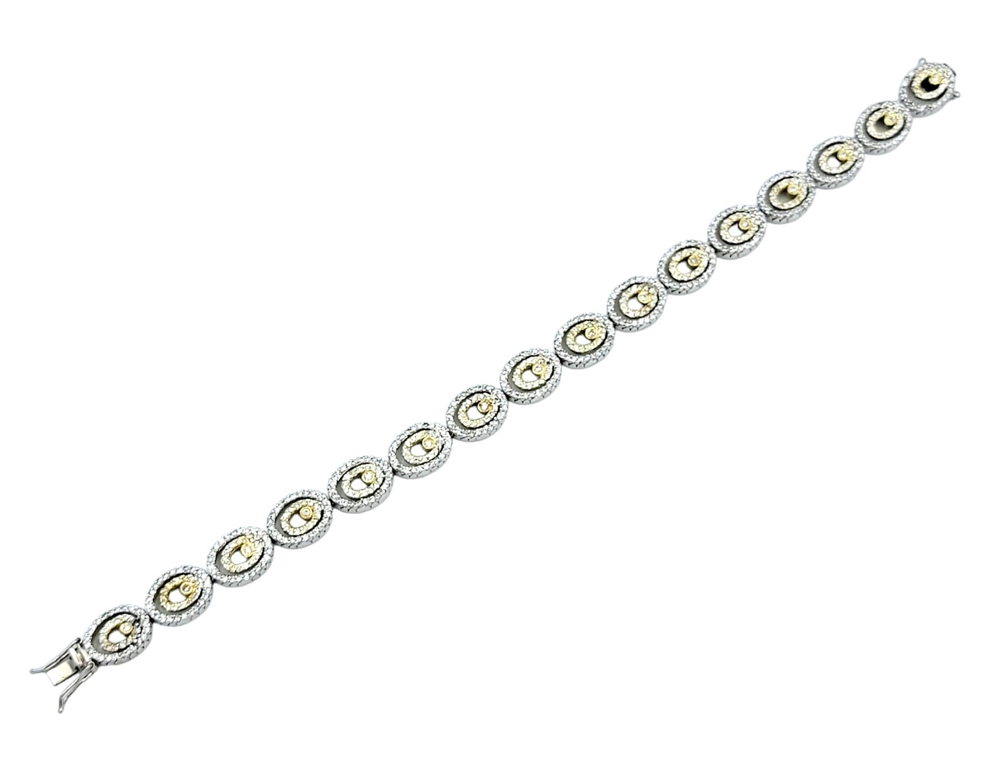 This exquisite diamond bracelet is a testament to the artistry of fine jewelry, crafted in luxurious 14 karat gold with a striking combination of white and yellow gold. The bracelet features a series of oval links, each intricately designed with