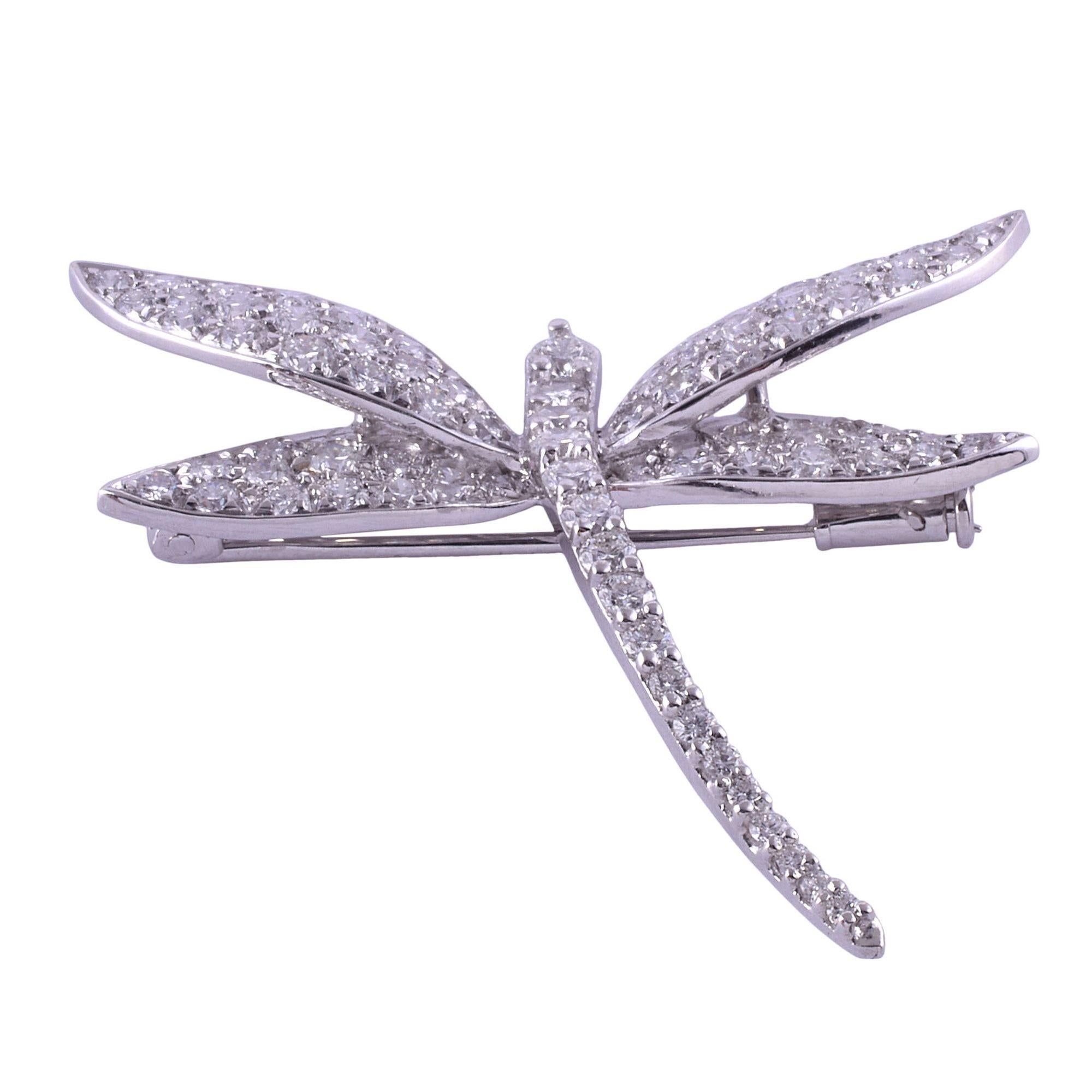 Estate pave diamond dragonfly brooch. This estate dragonfly brooch is crafted in 18 karat gold with rhodium plating. There are 79 full cut diamonds at 2.20 carat total weight having VS1-2 clarity and H-J color. The white gold diamond dragonfly pin