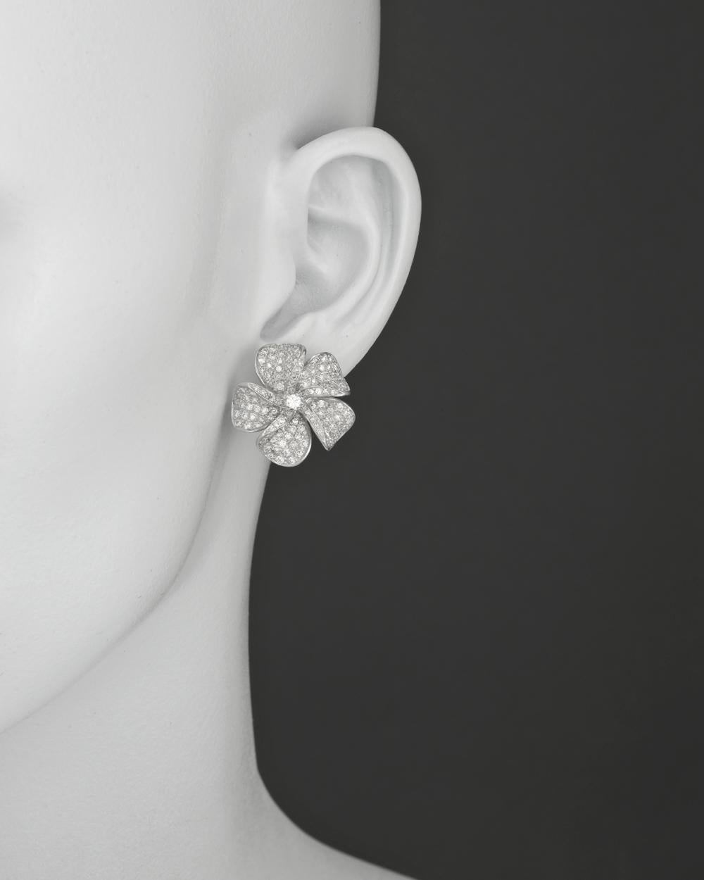 Pavé diamond flower earclips in 18k white gold. Round-cut diamonds weighing 1.75 total carats. 0.8