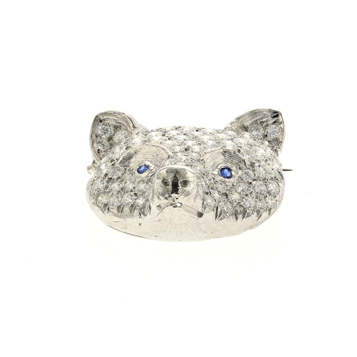 Fox head pin composed of platinum and pavé set diamonds.   There are 98 round brilliant-cut diamonds with a total carat weight of 4.80; F-G color and VVS-VS clarity.  The eyes are two round sapphires totaling .05 carats.  Measures 7/8 inches by 7/8
