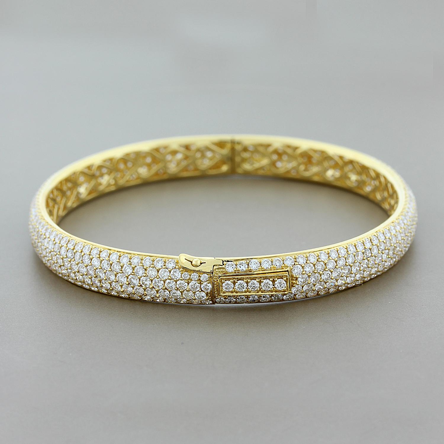 This oval shaped eternity bracelet fits with the natural curve of the wrist. 8.13 carats of round cut, colorless VS quality, pave set diamonds are set throughout the bracelet, including the box clasp. Set in 18K yellow gold with an extra safety