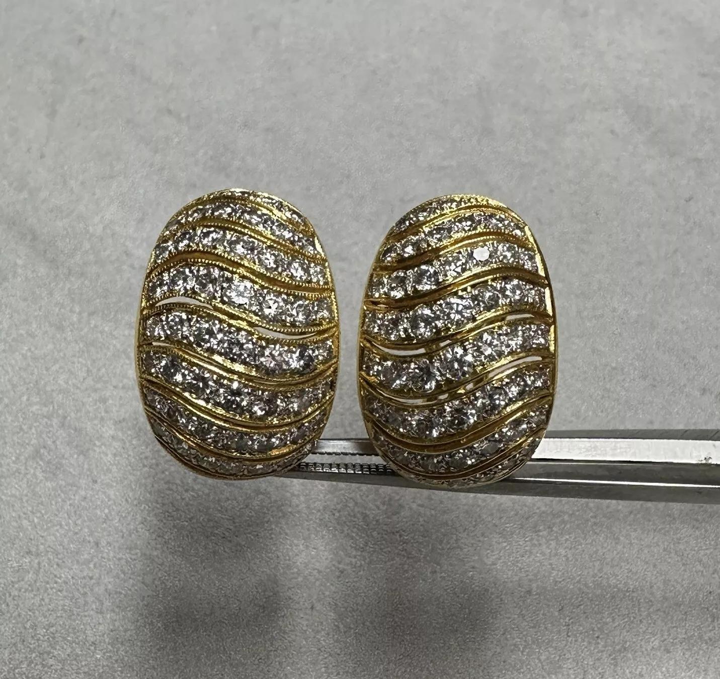 Pave Diamond Half Hoop Earrings 4.00 cttw in 18k Yellow Gold 

Diamond Hoop earrings feature 8 Rows of Round Brilliant Diamonds on each earring with an estimated total weight of 4.00 carats, all set in 18k Yellow Gold with Omega Clips.

Total