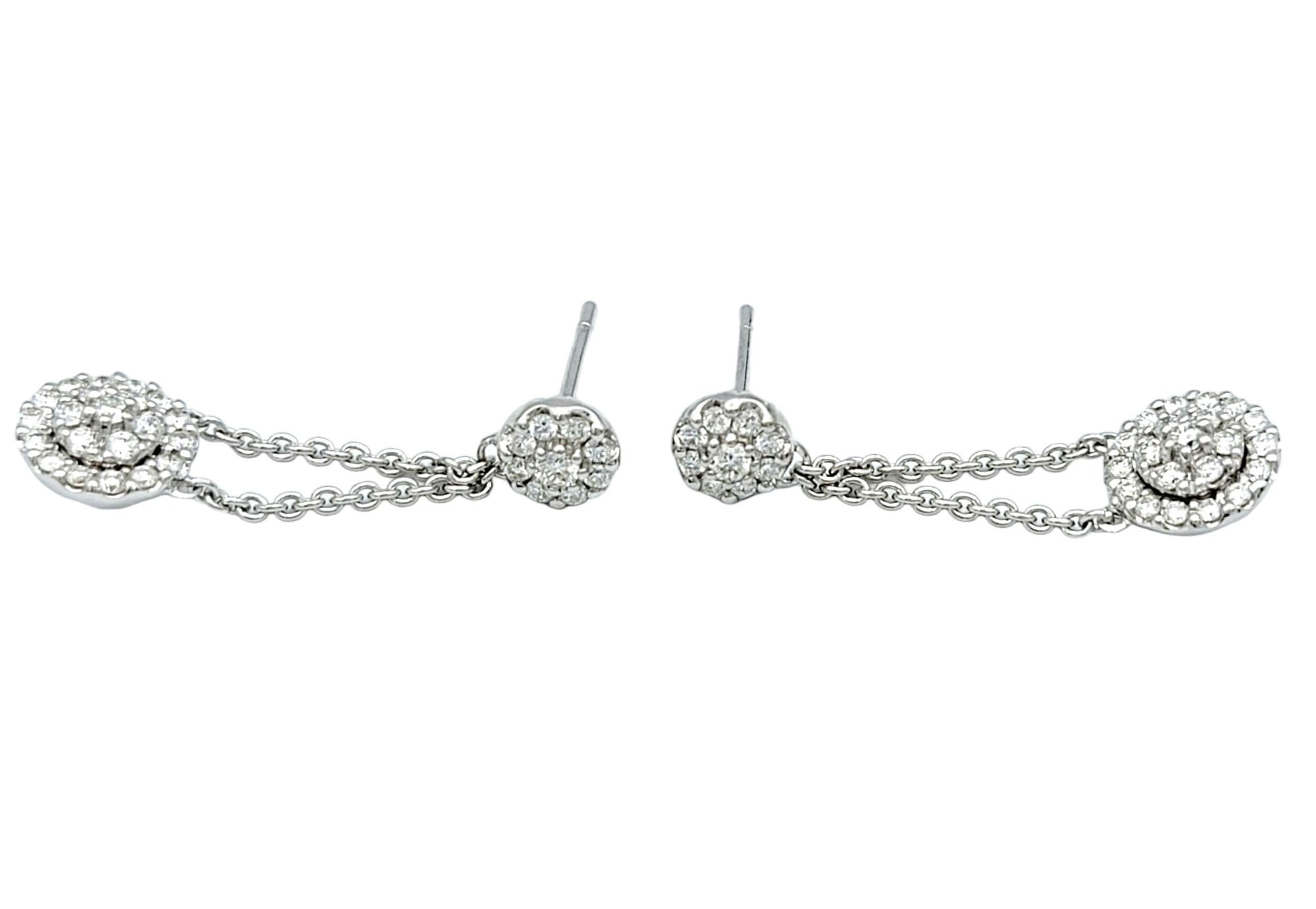 Contemporary Pavé Diamond Halo Dangling Drop Earrings Set in Polished 18 Karat White Gold For Sale