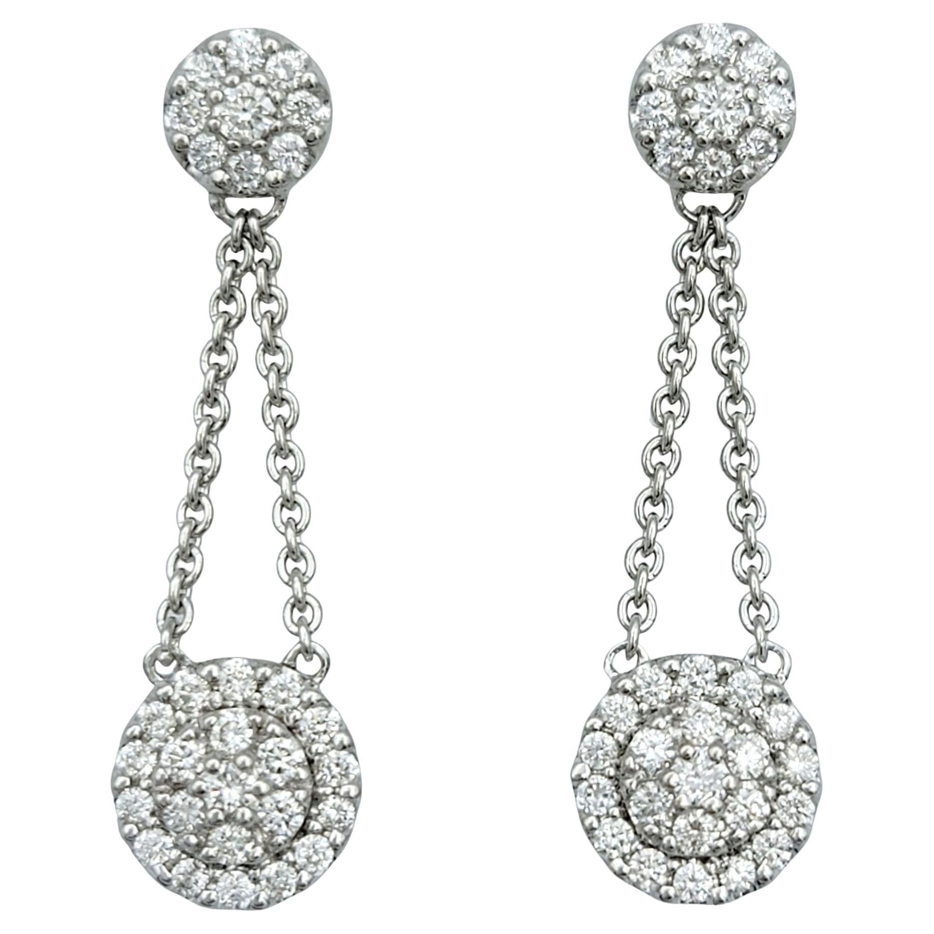 Pavé Diamond Halo Dangling Drop Earrings Set in Polished 18 Karat White Gold For Sale