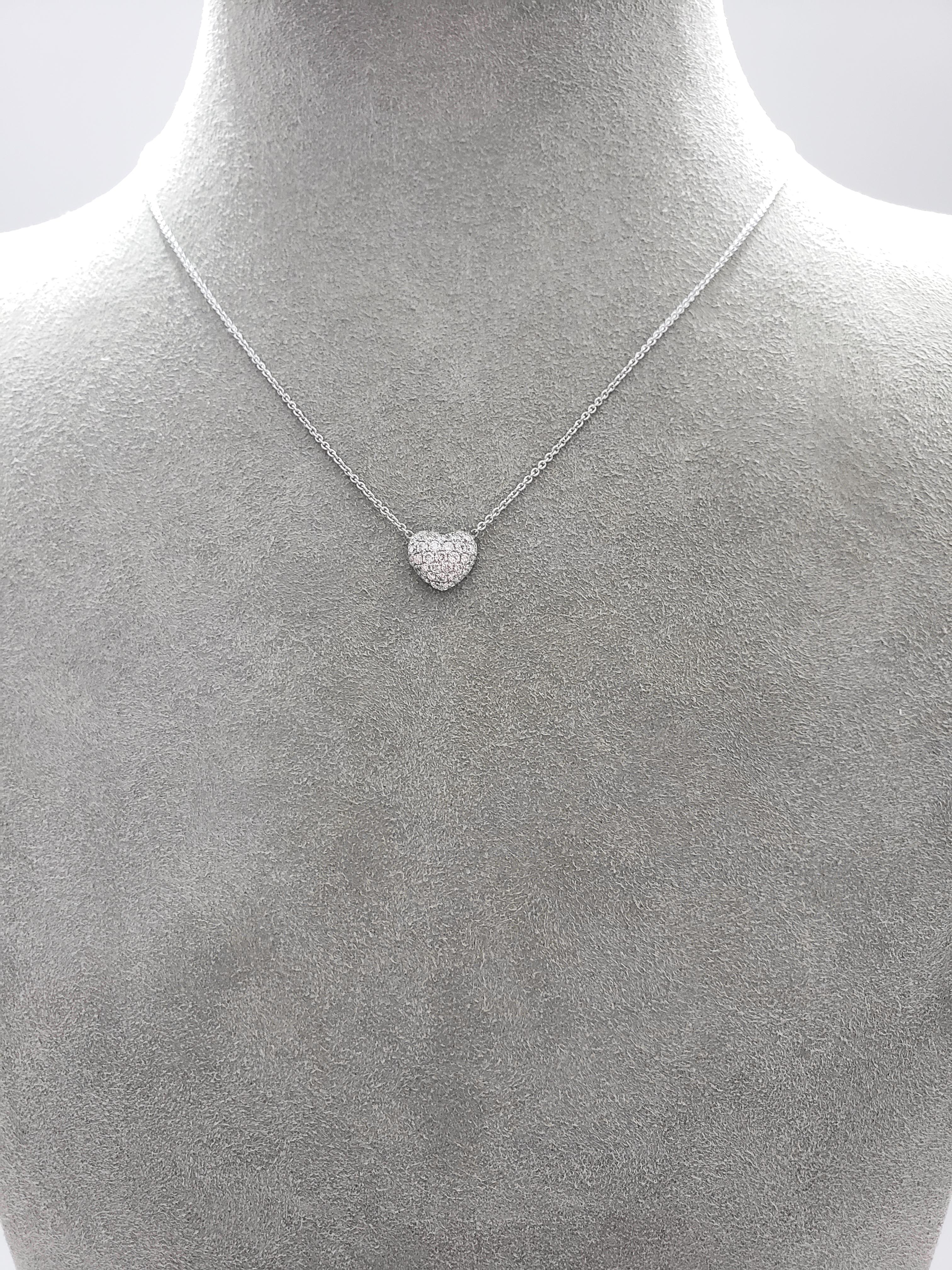 A 3D heart pendant set with micro-pave round diamonds. Diamonds weigh 0.52 carats total. Made in 18 karat white gold. Attached to an 18 inch white gold chain. 

Style available in different price ranges. Prices are based on your selection of the
