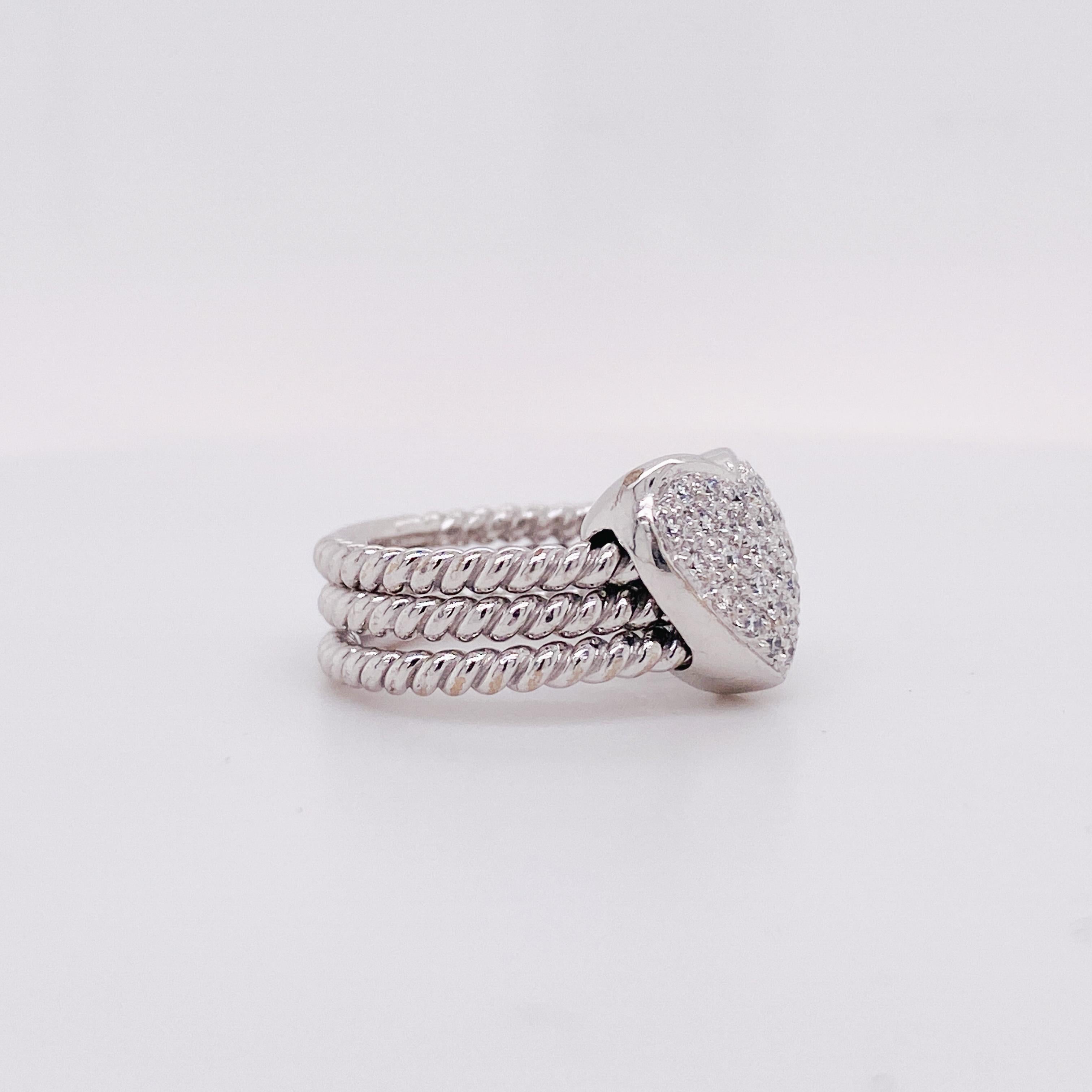 This beautiful pave diamond heart ring isn't just a classy fashion statement, it's also great for fidgeters! The pave heart moves around its 18K white gold twisted bands. There is a cursive 'M' inscribed underneath the pave heart. The pave diamonds