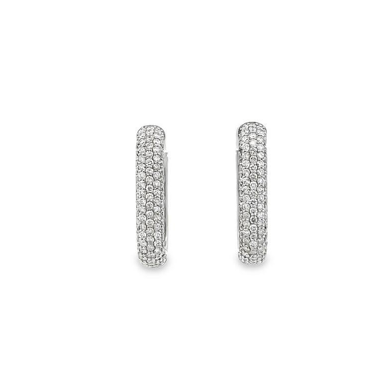 These hoops are a perfect combination of style and elegance. They feature 2.50 carats of white diamonds that are ethically sourced and set in 14K white gold. The pave setting design adds a touch of everyday glamour. The lightweight hoops are crafted