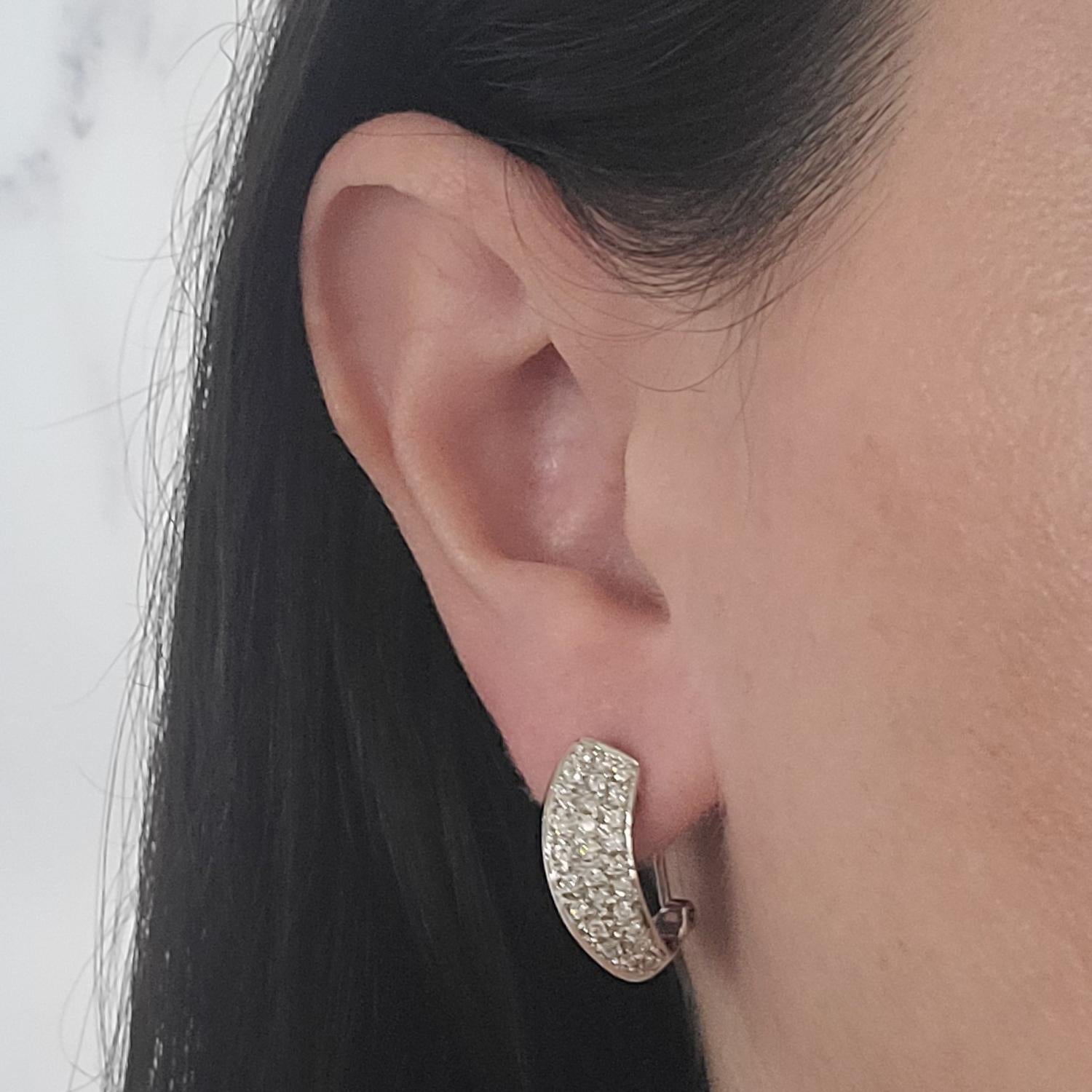 14 Karat White Gold Pave Hoop Earrings Featuring 54 Round Brilliant Cut Diamonds of SI Clarity and H Color Totaling Approximately 1.00 Carat. Pierced Post with Omega Clip Back. Finished Weight Is 6.8 Grams.