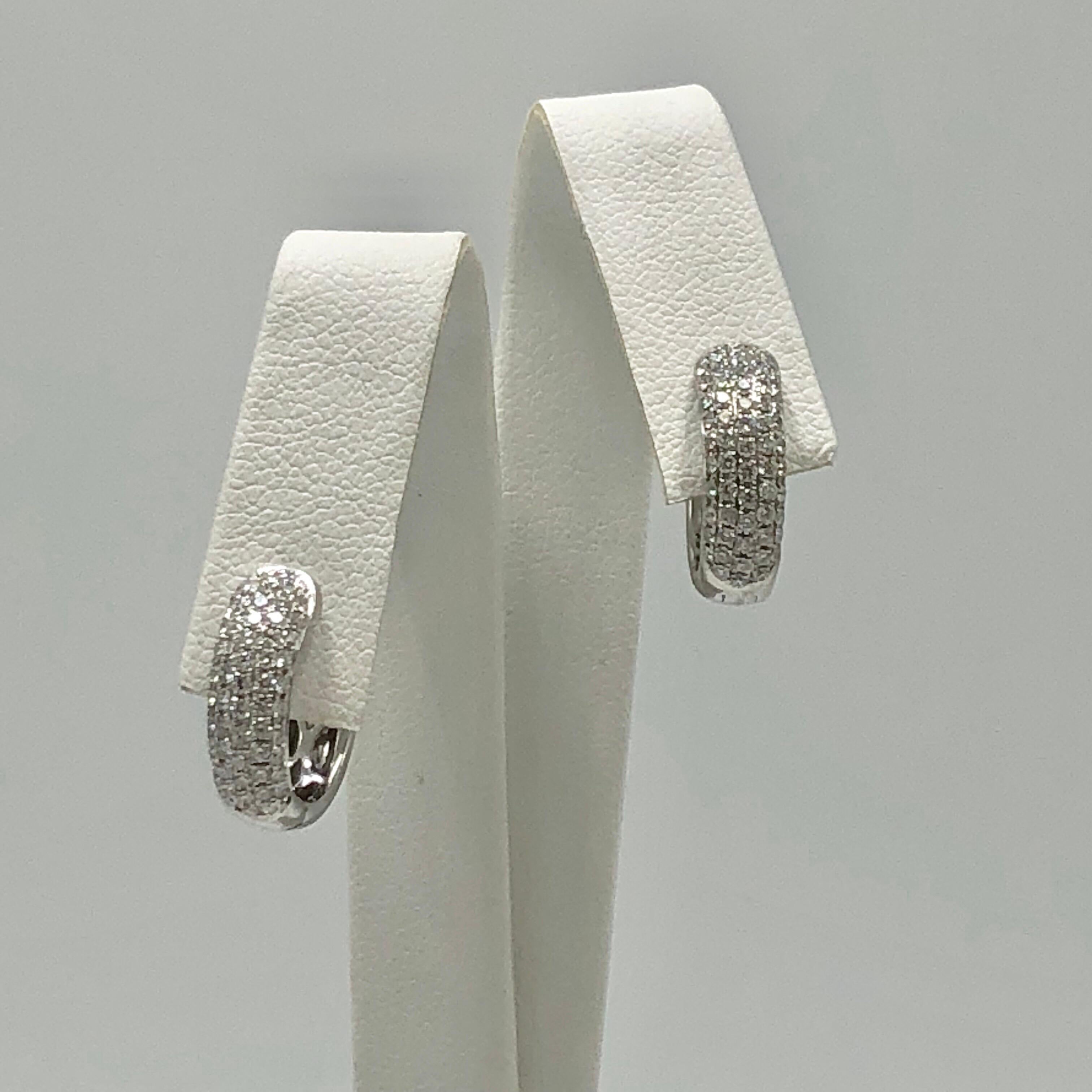 Give your look a little sparkle with these classic 18 Karat White Gold Pave Diamond Huggie Earrings. With .88 cts of diamonds, the versatility of their design makes them perfect for casual or formal occasions!

Stamped '18K Jye's'