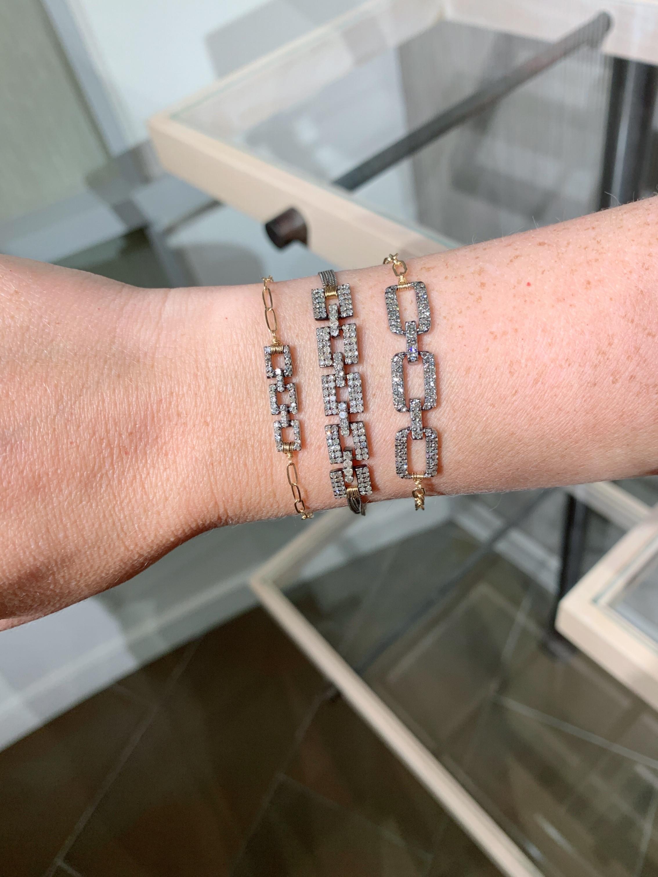 Geometric Triple Links Bracelet by Dana Kellin featuring three black-rhodium sterling silver links embedded with pave diamonds and intricately wire-wrapped on to a 14k yellow gold oval link chain with silver diamond bead accents and 14k gold lobster