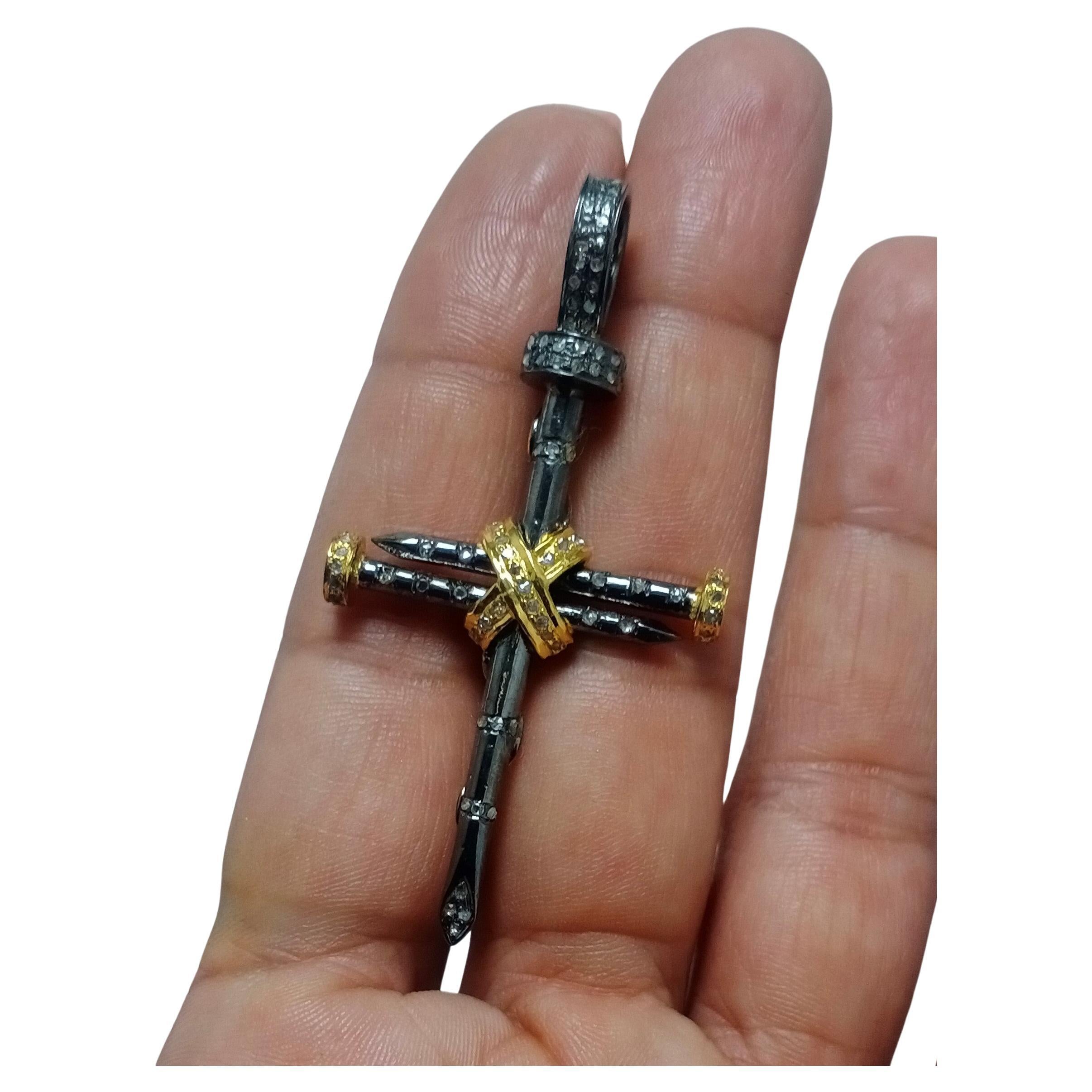 This is a beautifully crafted pendant in sterling silver with natural pave diamonds. The cross has been crafted with 925 silver nails. The dual tone of the silver enhances the beauty of this jewel to manifolds. The detailing's of the nails have been