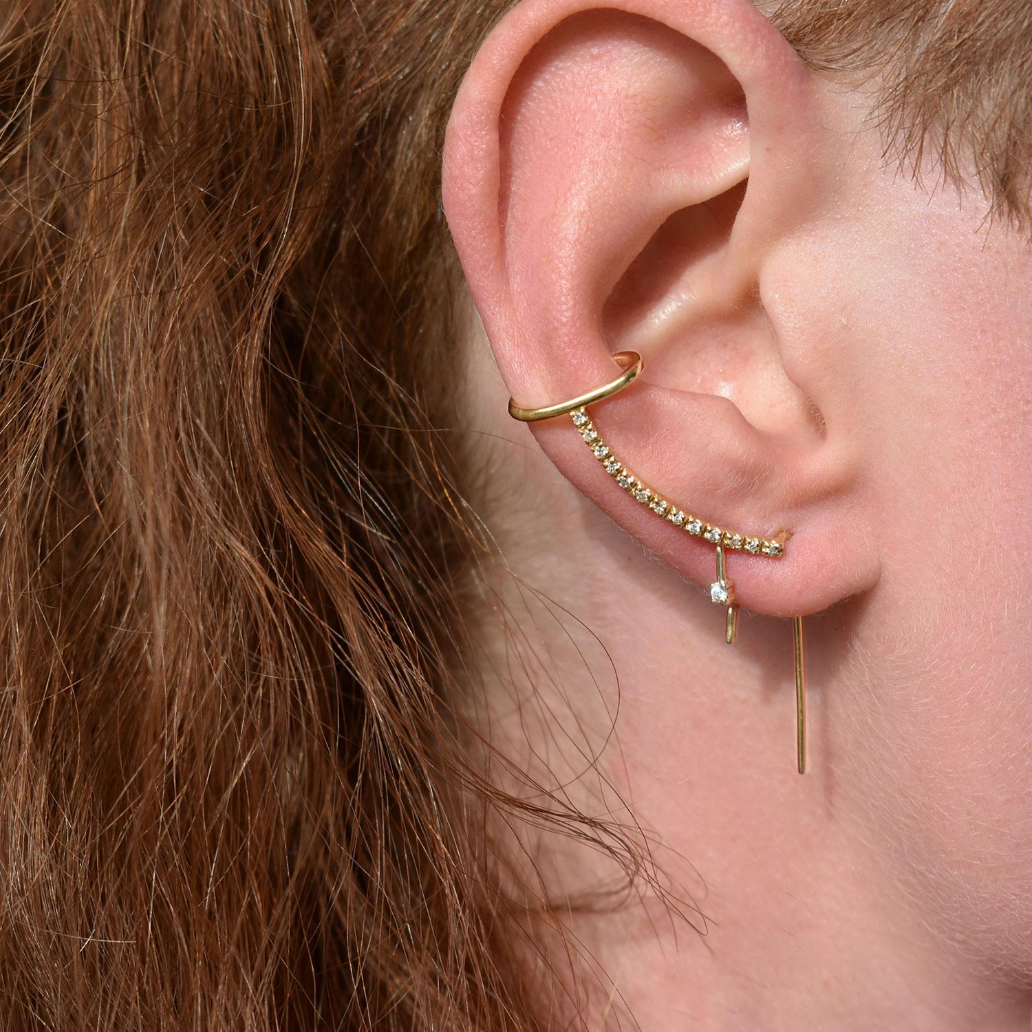 The Pave Diamond Cuff Needle Gold Earring is a statement earring in solid 14k gold featuring an arch of diamonds that reflect the soft sunlight. This style earring fallows the outline of the ear and ends with a comfortable cuff.

How to wear it: