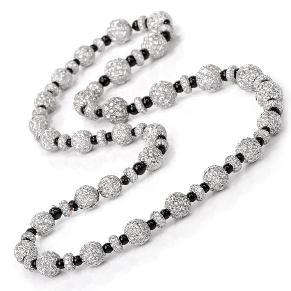This appealing diamond bead necklace of classic elegance is crafted in solid platinum, weighing 129.6 grams and measuring 23 inches long. The necklace incorporates round graduated platinum beads of two distinct sizes measuring from 12mm to 3mm in