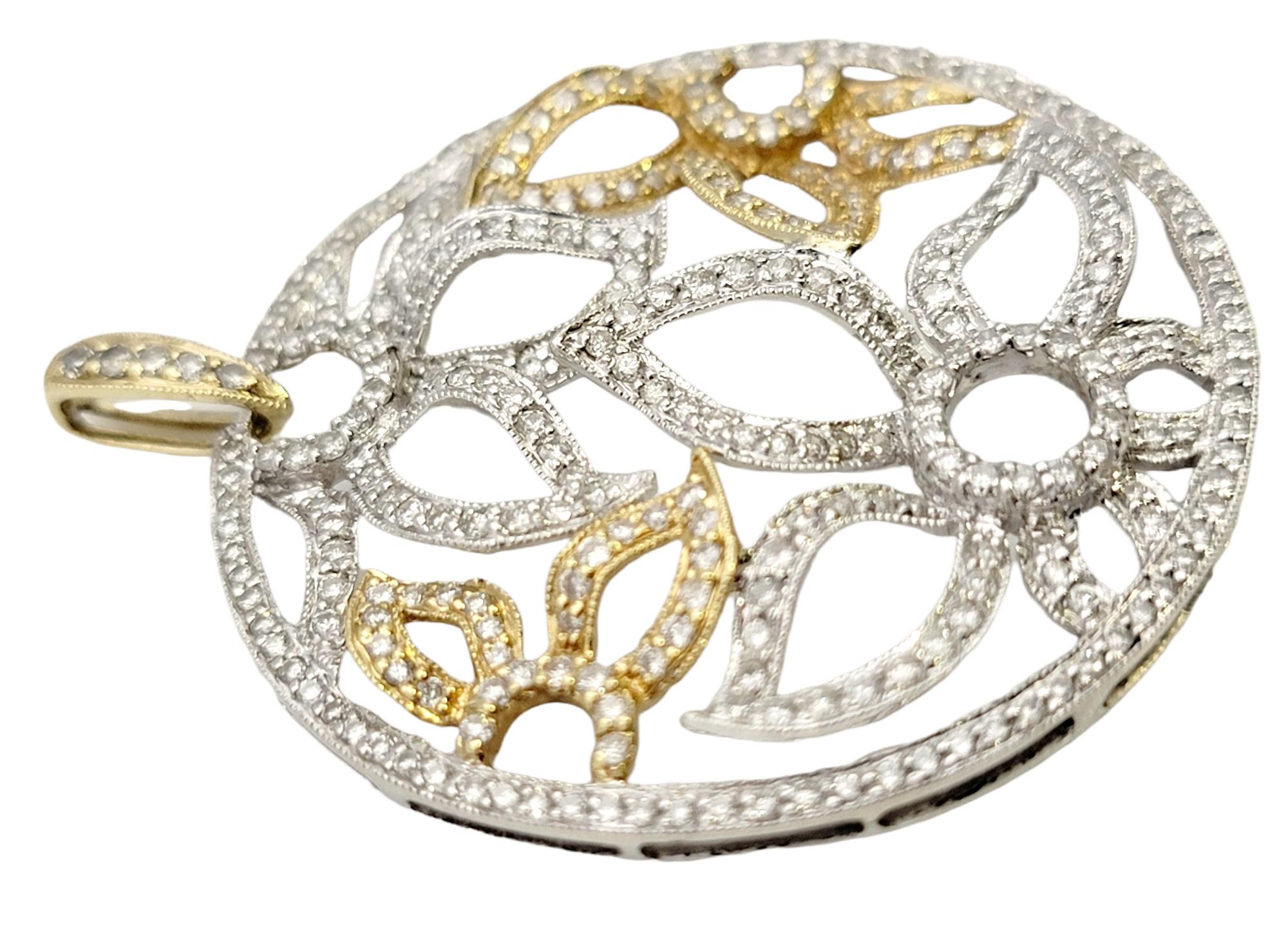 Stunningly sparking diamond pendant with contemporary flower motif. This gorgeous piece features a glittering pave diamond disc filled with an open floral design set in yellow and white gold. The intricate petals curve slightly throughout, really