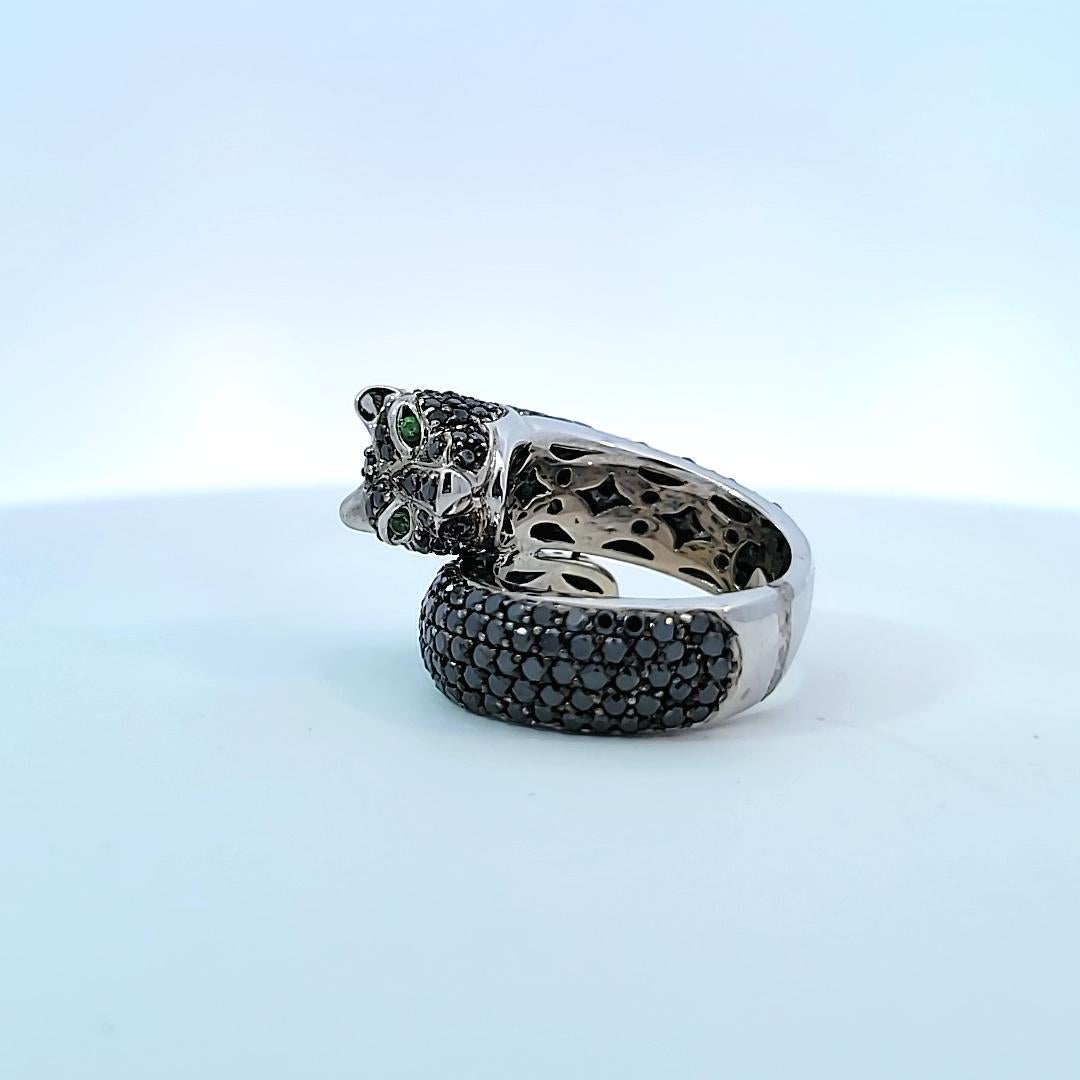 Not just for cat lovers!  This unusual cat shaped ring is in 14 karat white gold and supports approximately 5.75 carats of black/brown diamonds and tsavorite eyes!