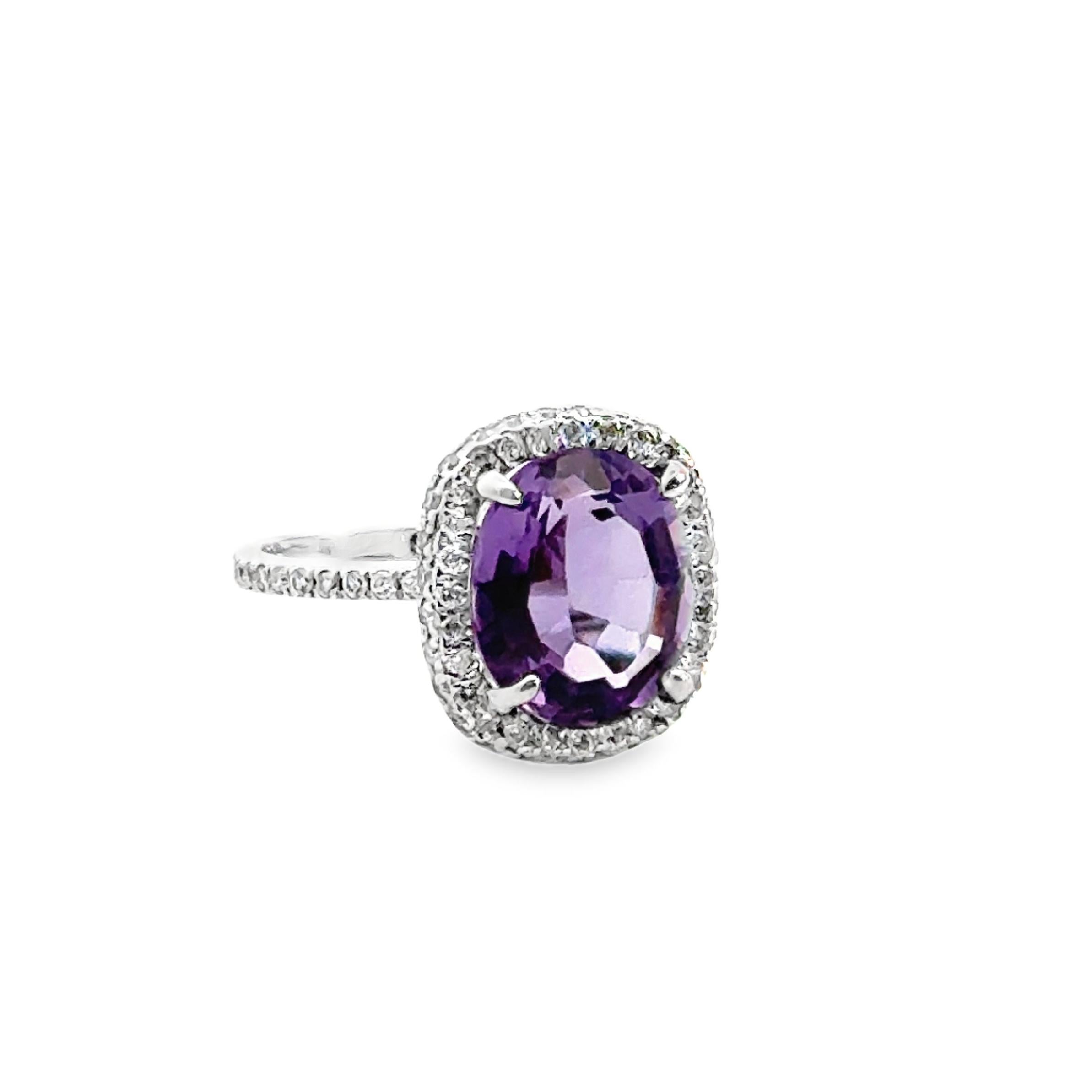 18 karat white gold, custom made. 

One purple oval amethyst center, 3.75tw. Hidden halo pave diamond setting and half-way diamond band, 0.50tw.

Size 6.