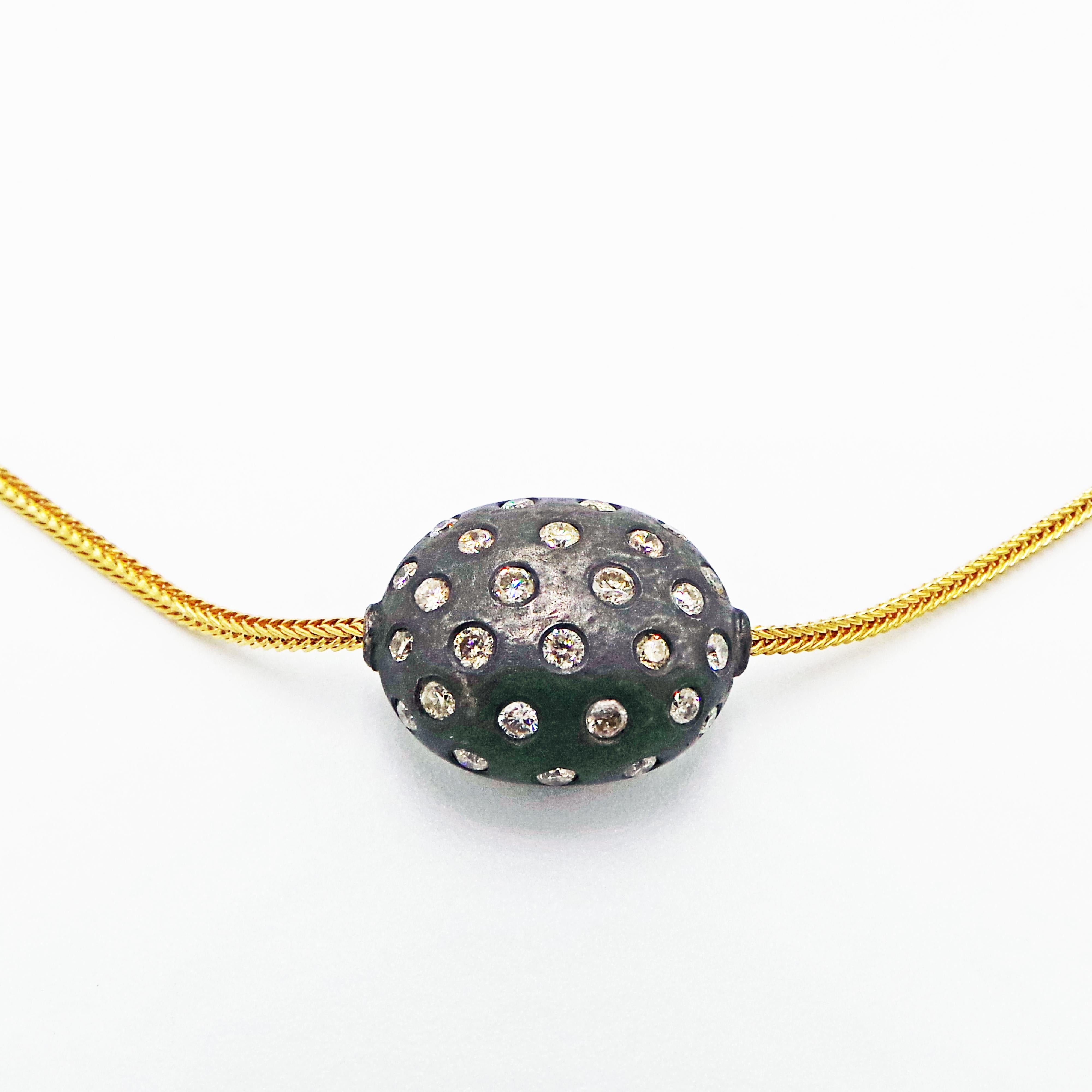 Necklace:  Large multi-diamond pavé oxidized sterling silver ball bead on 18k yellow gold foxtail chain.
Earrings:  Small multi-diamond pavé oxidized sterling silver bead on 18k yellow gold french wires.

This necklace and earring set is versatile,