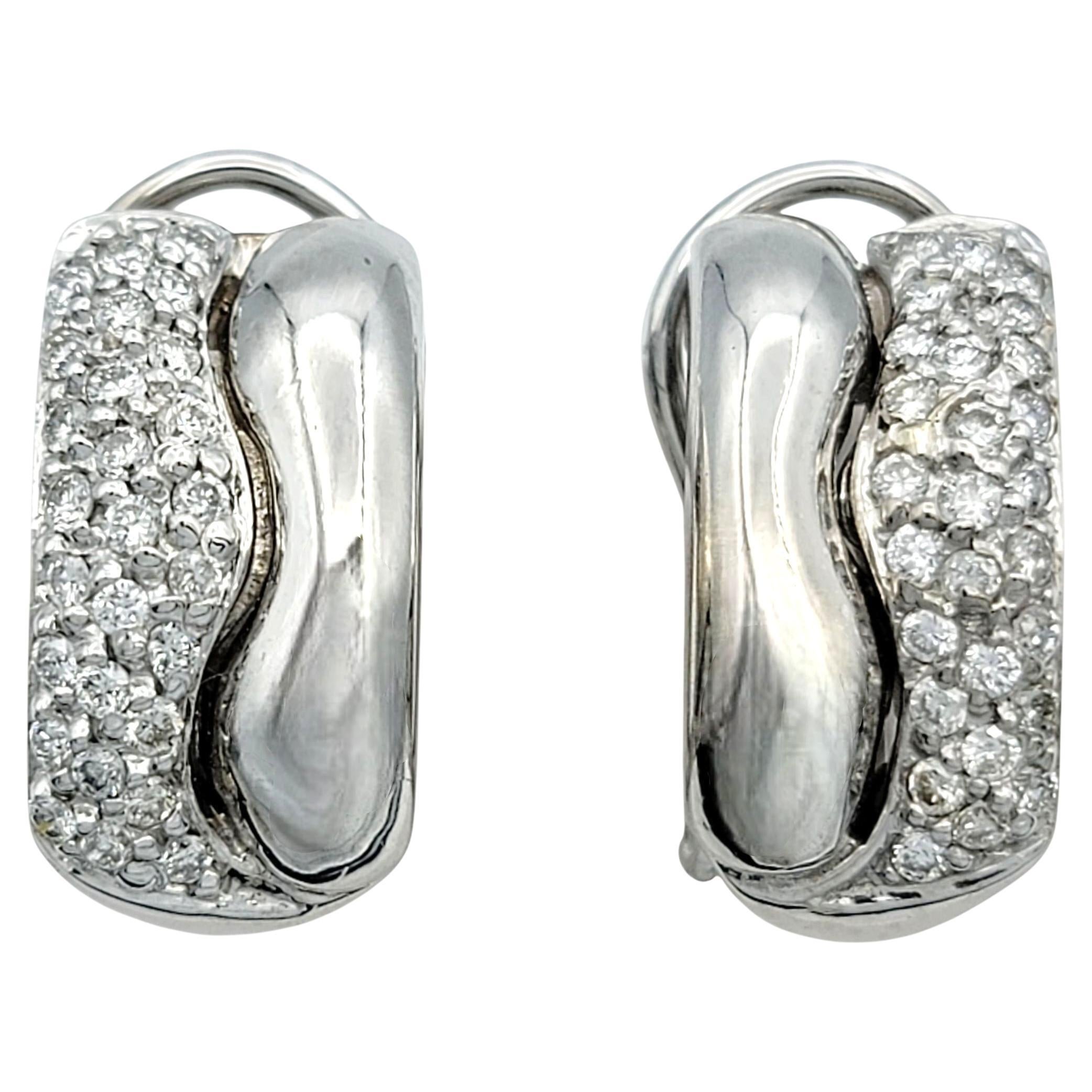 Diese eleganten Diamant-Wellenohrringe verleihen dem zeitlosen Funkeln einen modernen Touch. Die aus 14 Karat Weißgold gefertigten Ohrringe zeigen ein geschwungenes Wellendesign, in dessen Kurve runde Diamanten im Brillantschliff in Pavé-Fassung