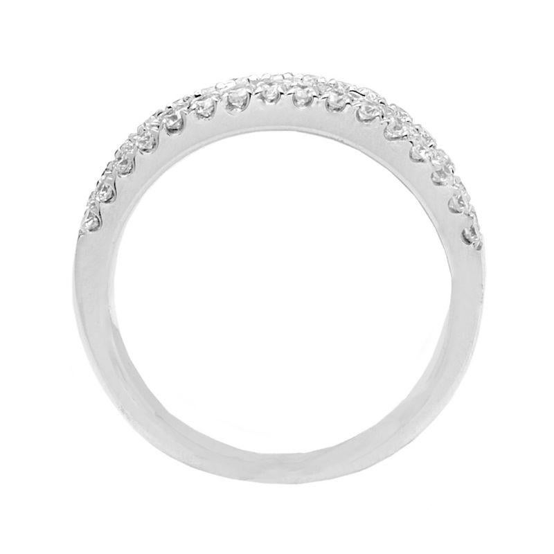 This incredible anniversary band beautifully crafted in 14k white gold, this ring is set with brilliant round diamonds across the center. Glistening borders set with smaller round accent diamonds flank this center ribbon in a sparkling tribute. This