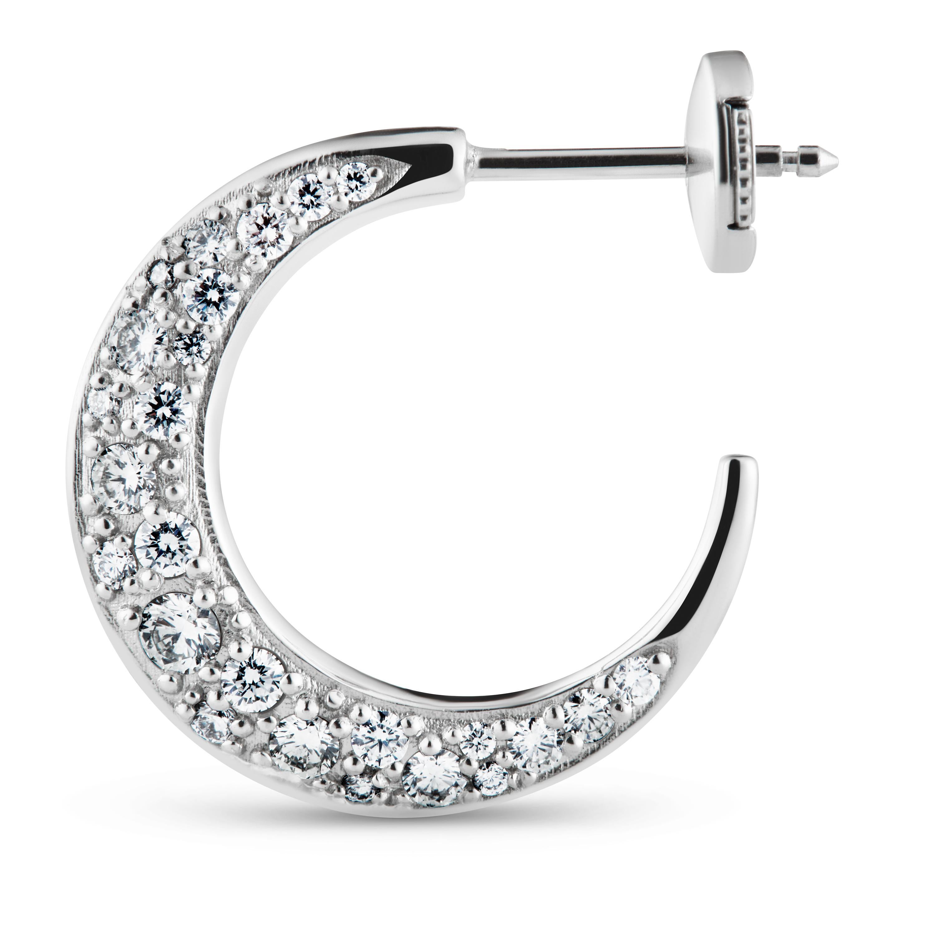 Diamond Hoops in 18kt white gold is set with 50, a total of 0.75 carat, brilliant cut traceable diamonds.

Each of the 50 diamonds are hand set so they underline the shape of the earring providing the perfect sparkle and light reflection. 

All