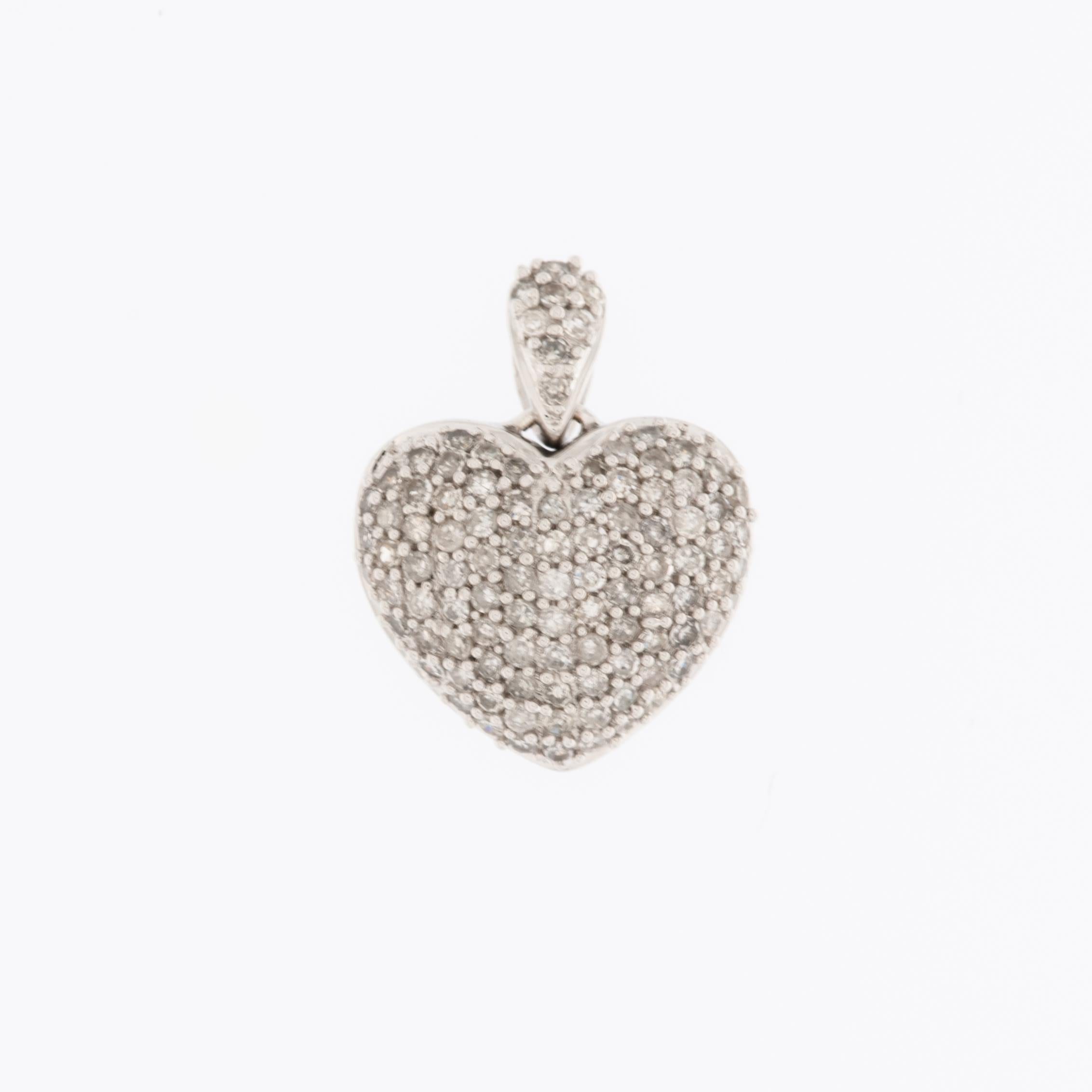 The Pavé Heart Pendant in White Gold with Diamonds is a stunning emblem of grace and elegance. Crafted from 18-karat white gold, this pendant boasts a contemporary design adorned with dazzling brilliance.

The pendant is entirely adorned with