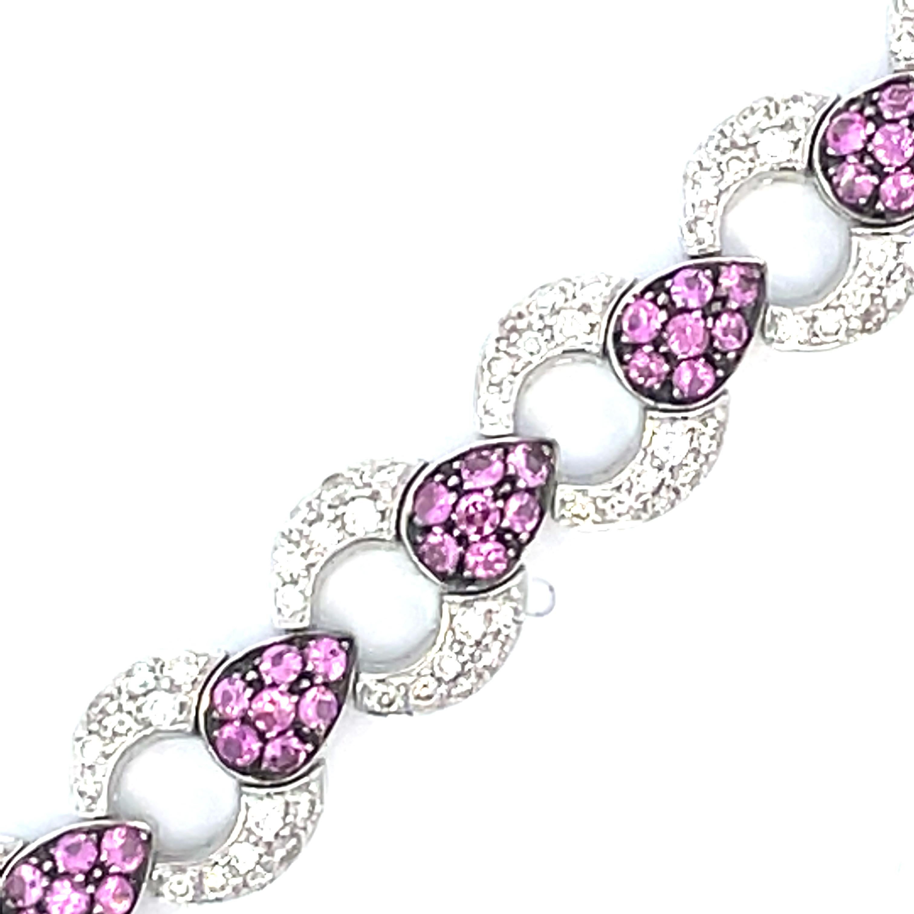 An elegant  pave link bracelet with alternating pave natural white diamond and  a black rhodium finish around the natural pink sapphire pear shape in 18kt white gold.

112 natural pink sapphires weighing 2.81ct total weight

224 natural diamonds