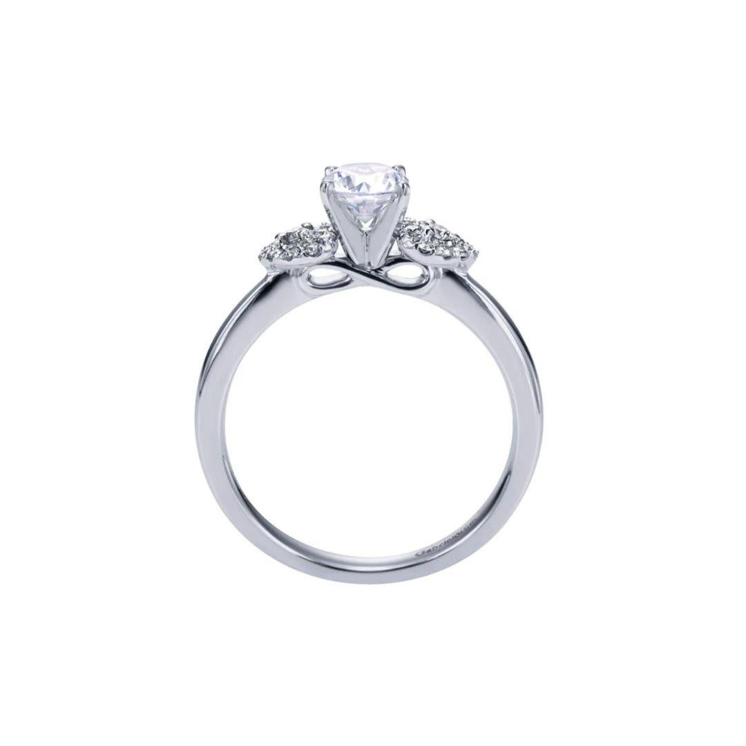 Ladies' 14k White Gold Diamond Engagement Ring. Delicate leaf shaped clusters of white diamonds flank the center diamond for a romantic playful look. Center diamond is included, 0.40ct, H color, SI3 clarity. Side diamonds are 0.14 ctw, H color, SI