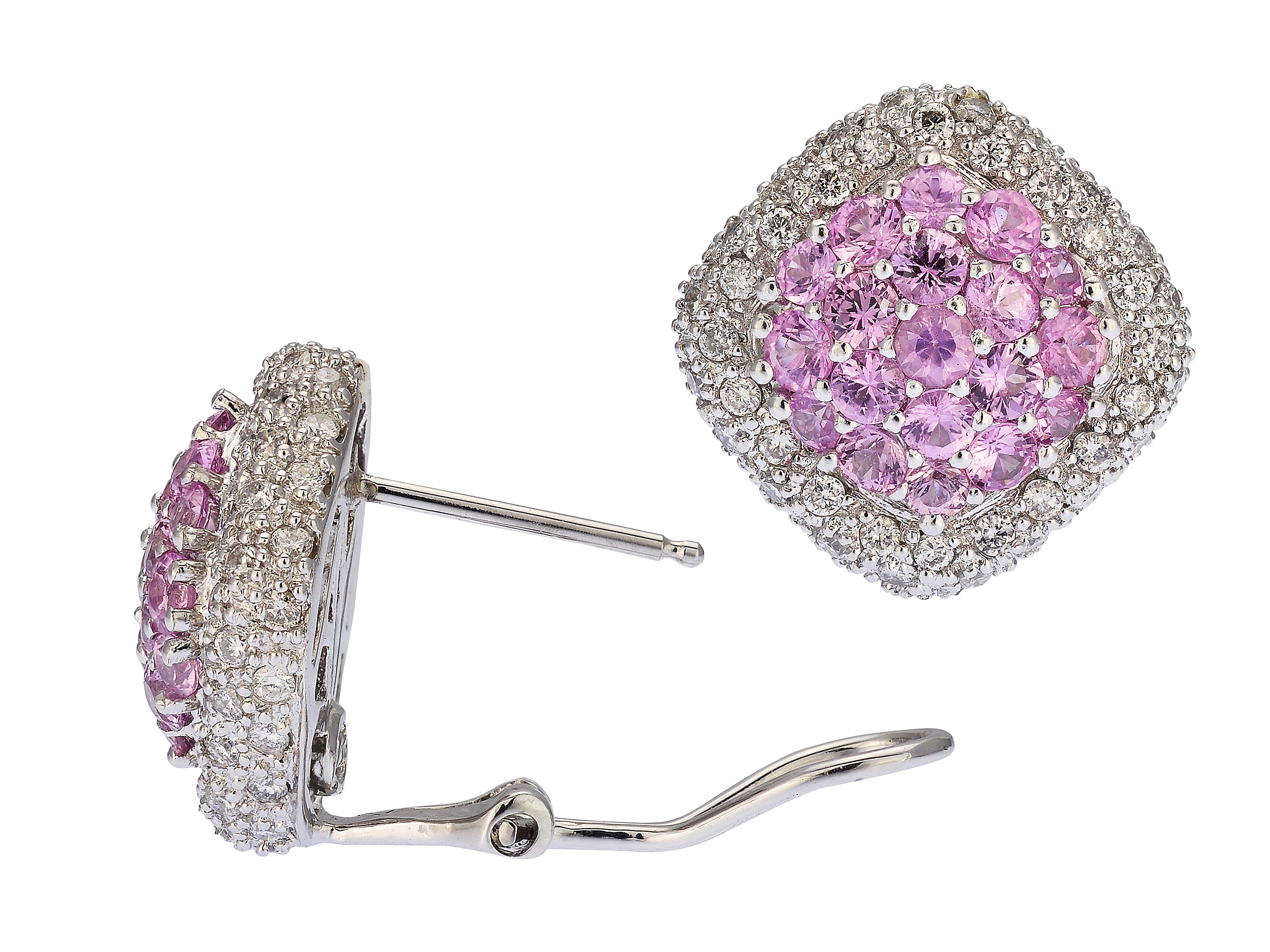 Beautifully crafted pink sapphire and diamond clip on earrings made in 18 karat white gold. They contain 38 round pink sapphires totaling approximately 2 carats, and 120 round diamonds totaling approximately 1.20 carats. The closure is an Omega