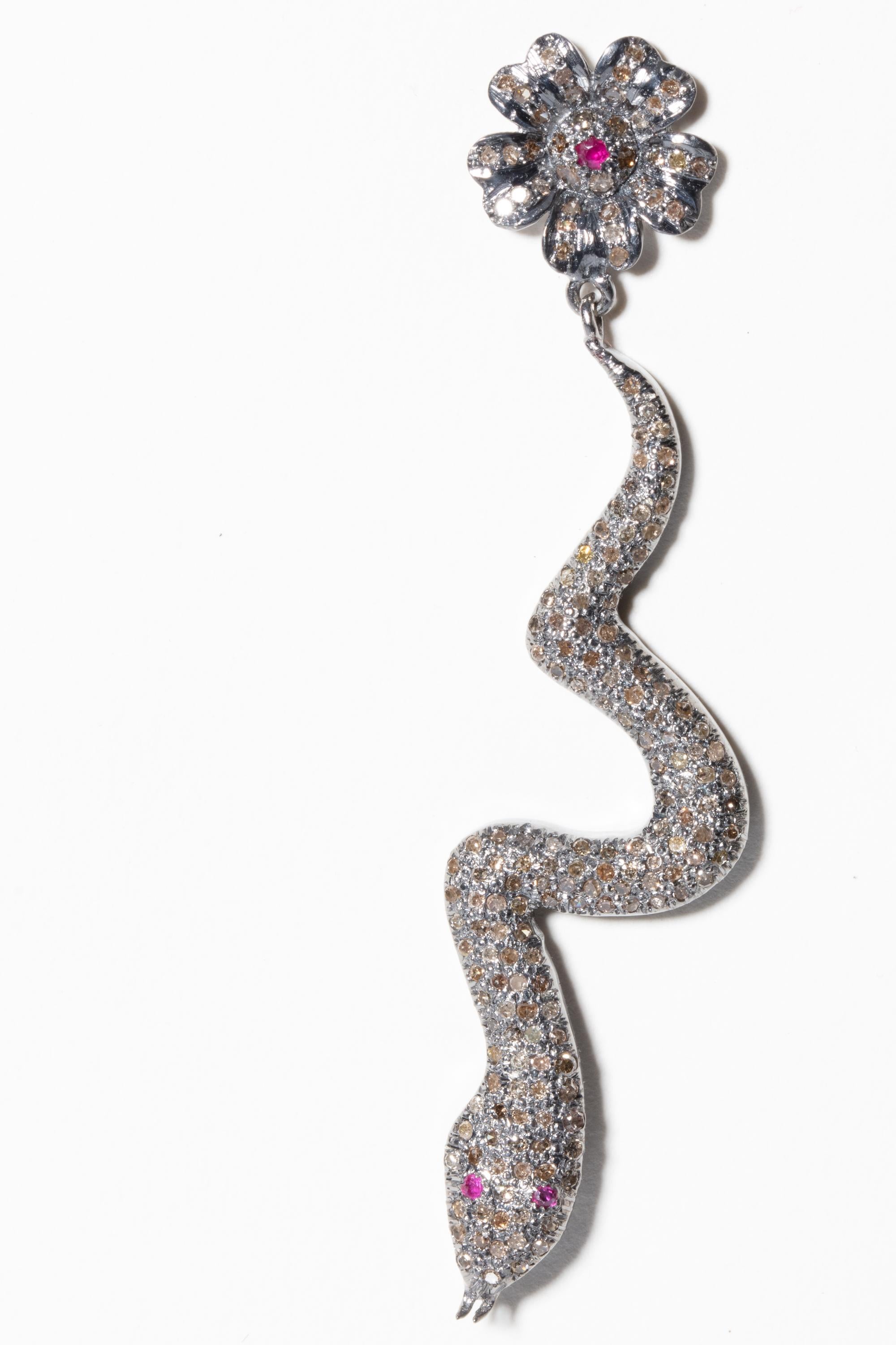 Pair of brilliant-cut, pave`-set diamond snake earrings with diamond flower motif posts with faceted ruby center.  Set in sterling silver with 18K gold post for pierced ears.  Weight of diamonds is 1.82 carats.