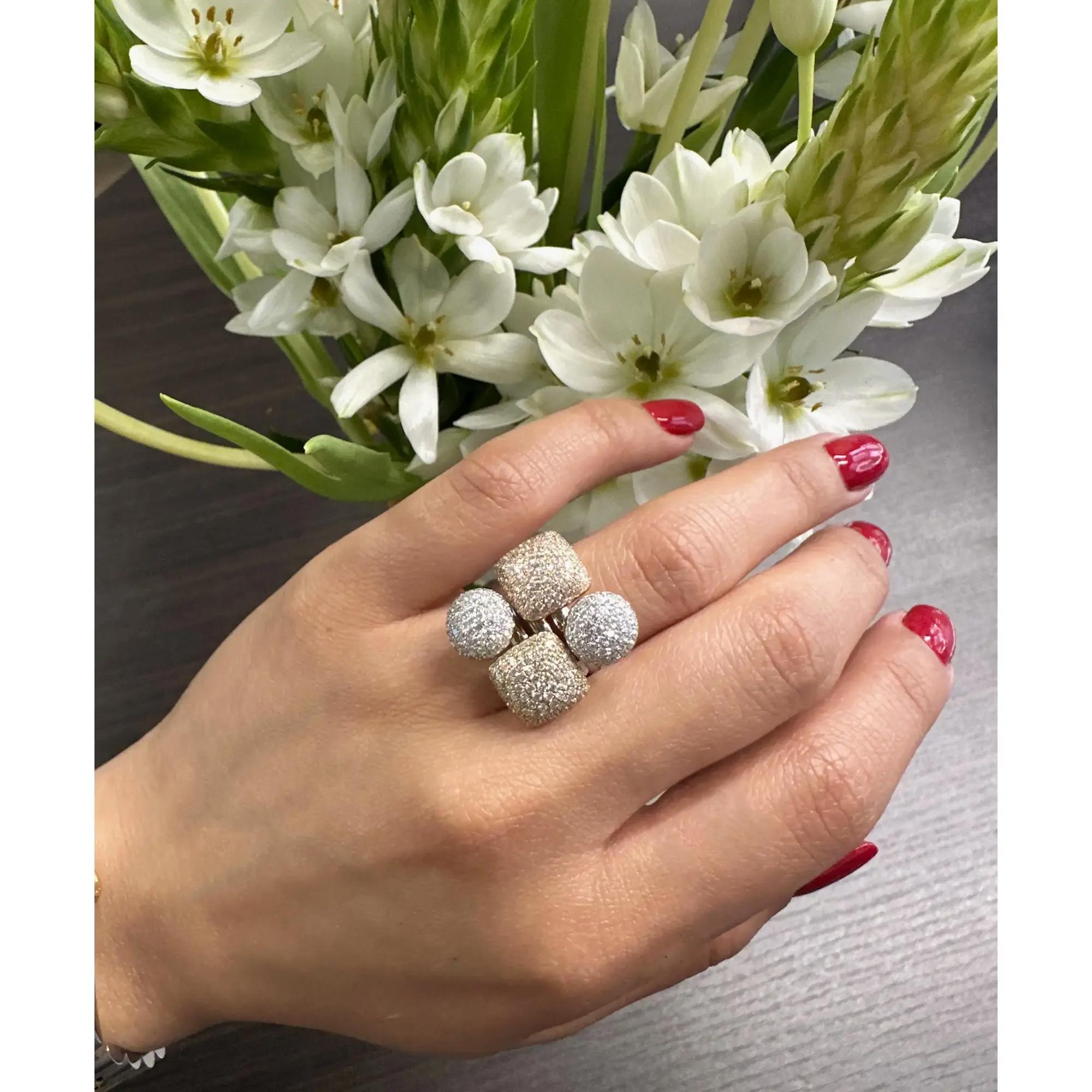 This stunning multi gold tone cocktail ring comes with a flashy statement look. A must have in your jewelry collection. The ring is crafted in 18K white, yellow and rose gold. Features round cut natural diamonds studded in a circular and square
