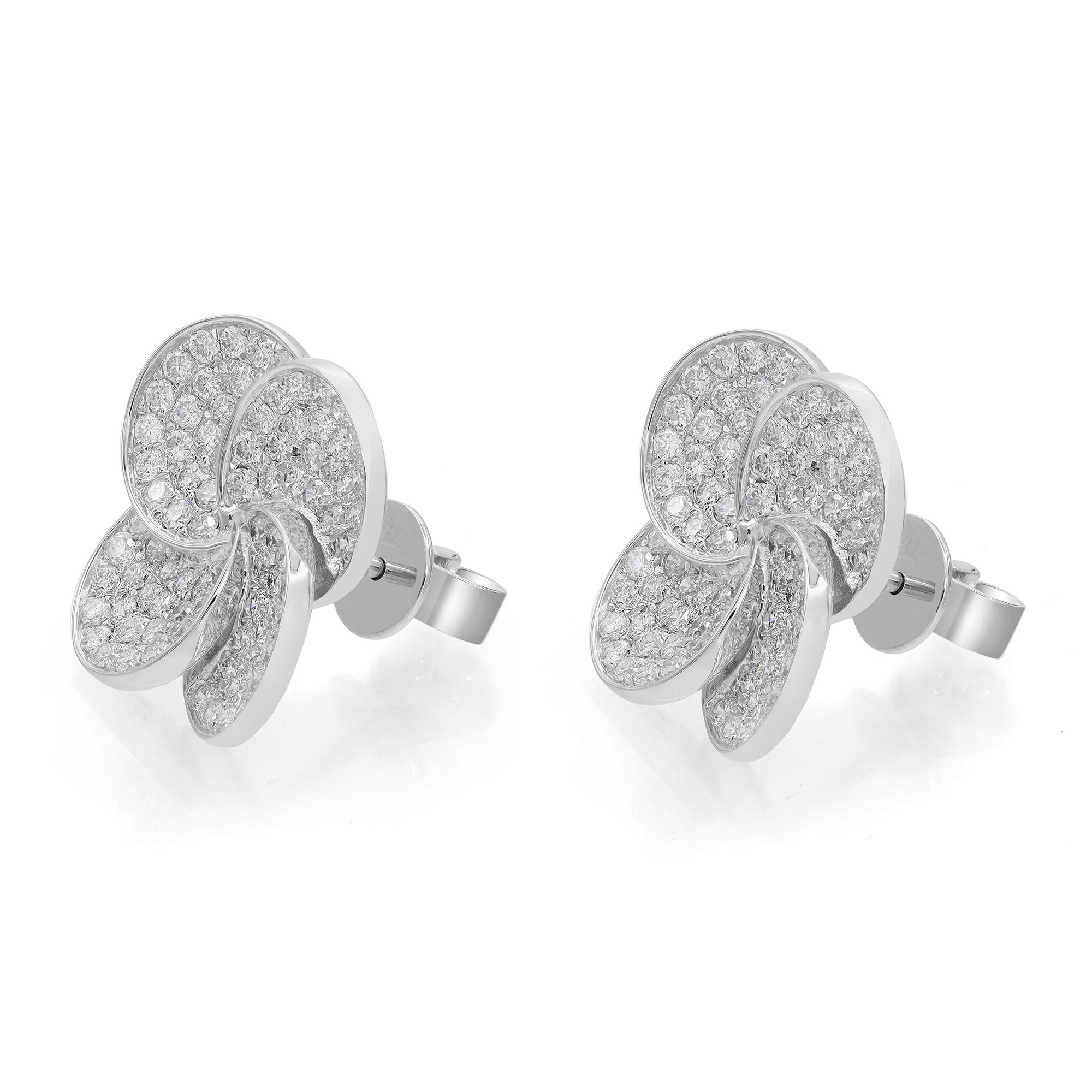 Diamonds in full bloom. These stunning diamond flower stud earrings are crafted in 18k white gold. Showcases pave set round brilliant cut diamonds weighing 1.44 carats. Diamond quality: color G-H and clarity VS-SI. Earring size: 14mm x 14mm. Total