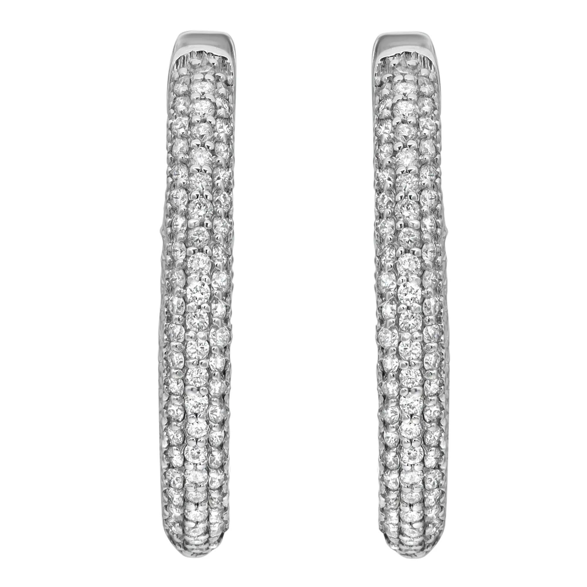 These stylish and elegant 14k white gold oval shaped hoop earrings feature pave set shimmering round cut diamonds. The diamonds embellish these earrings offering a dazzling look. Total diamond weight 1.00 carat. Diamond color G-H and SI clarity.