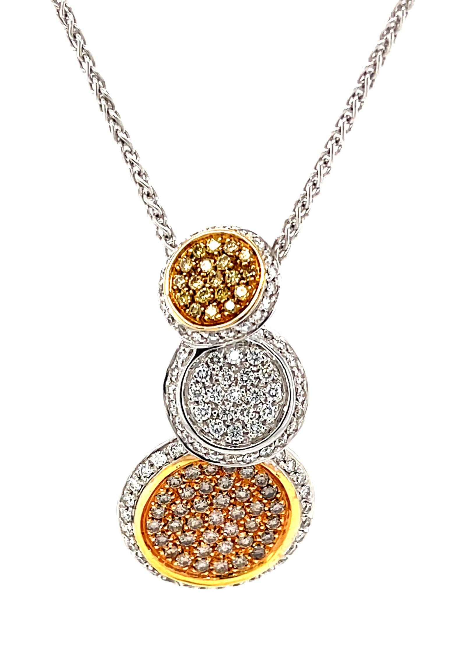 This stylish necklace features yellow, white and natural coffee brown diamonds pave set in 18k yellow, white and rose gold! Each of the three discs making up this contemporary design is a different size, set with one of the three colors of brilliant