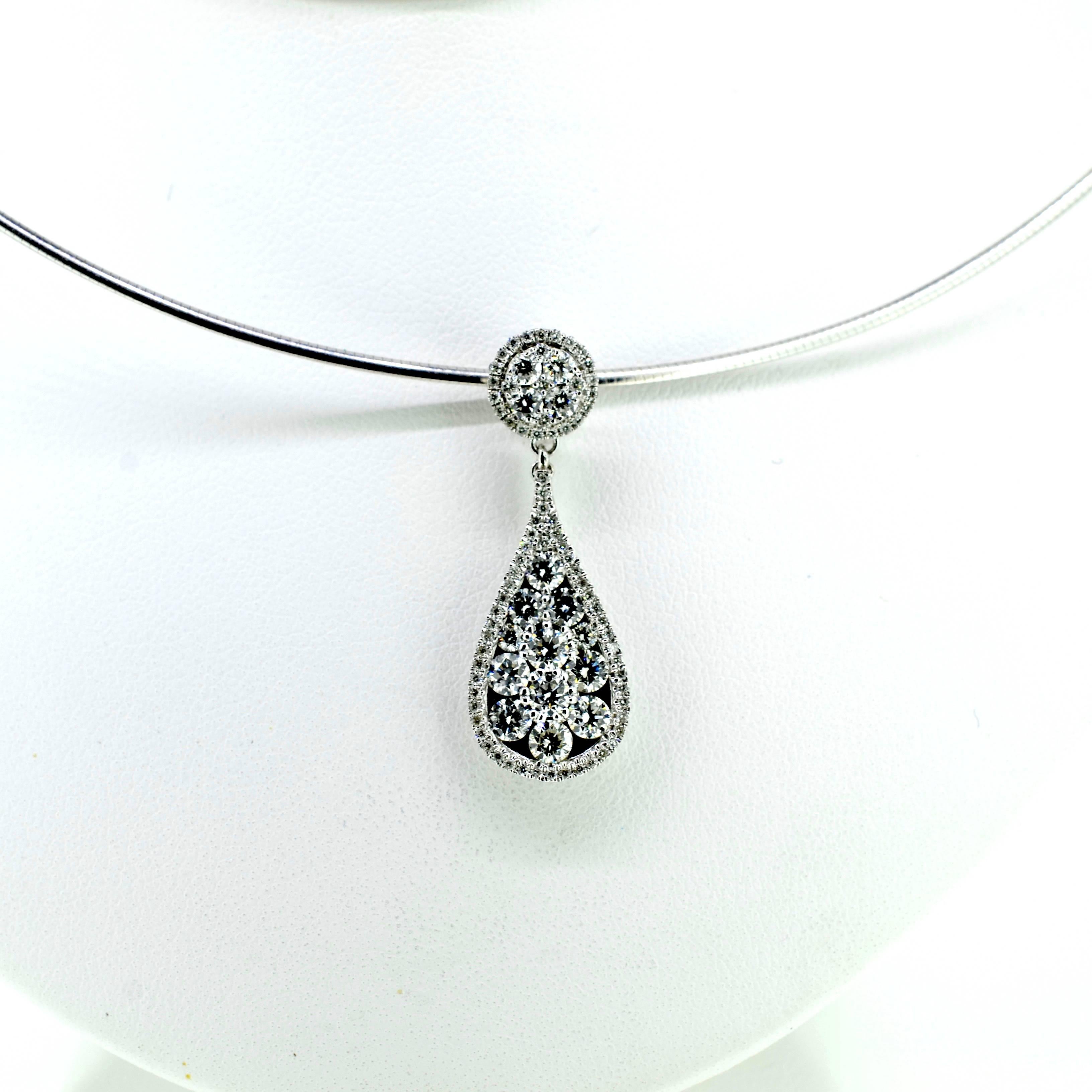 Pave set diamonds in a double drop pendant 1.25 inches long with round and teardrop shapes in 18kt white gold. 1.32ct total weight diamonds full cut VS clarity G-H color. 14kt gold neck wire 18 inches in length.