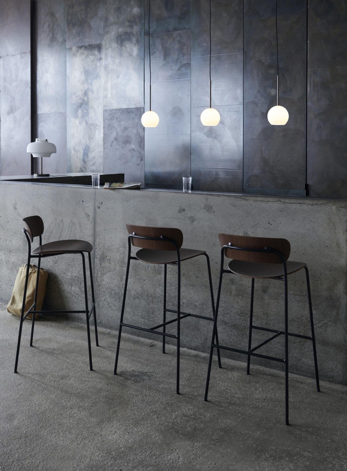 The Pavilion bar chair has an airy feeling, with fluid curves for the wood veneer seat and back which continue as lyrical lines in the steel tubes of the legs. 
The result is a silhouette that’s barely there. Ideal for furnishing an expansive bar