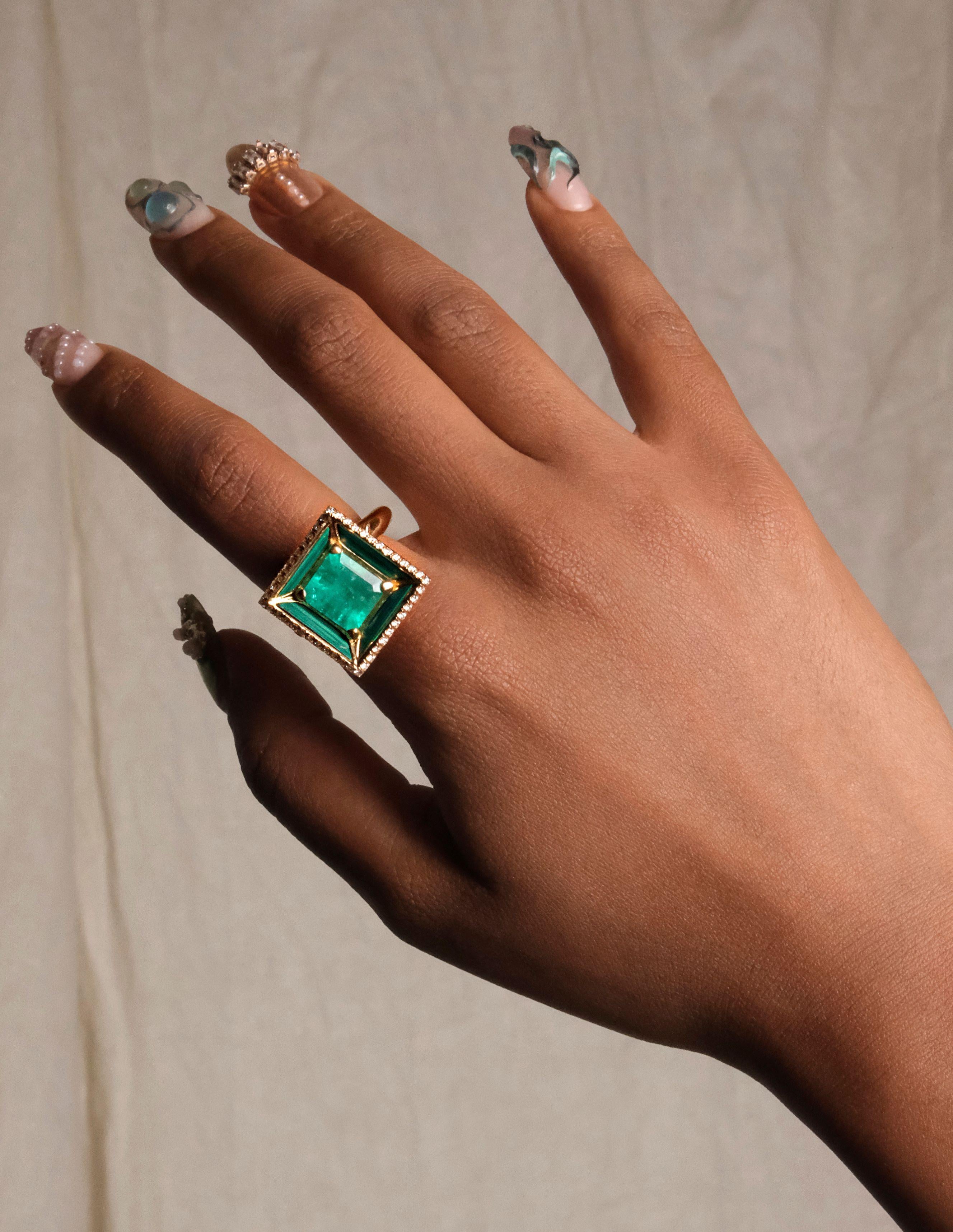 A beveled surface invokes a place of gathering rendered in 18k gold, textural green malachite. Set with an upturned emerald pyramid with diamond trim. A space for us. 0.6 inch height. 

Size 7 ring is available to ship.  All other sizes are