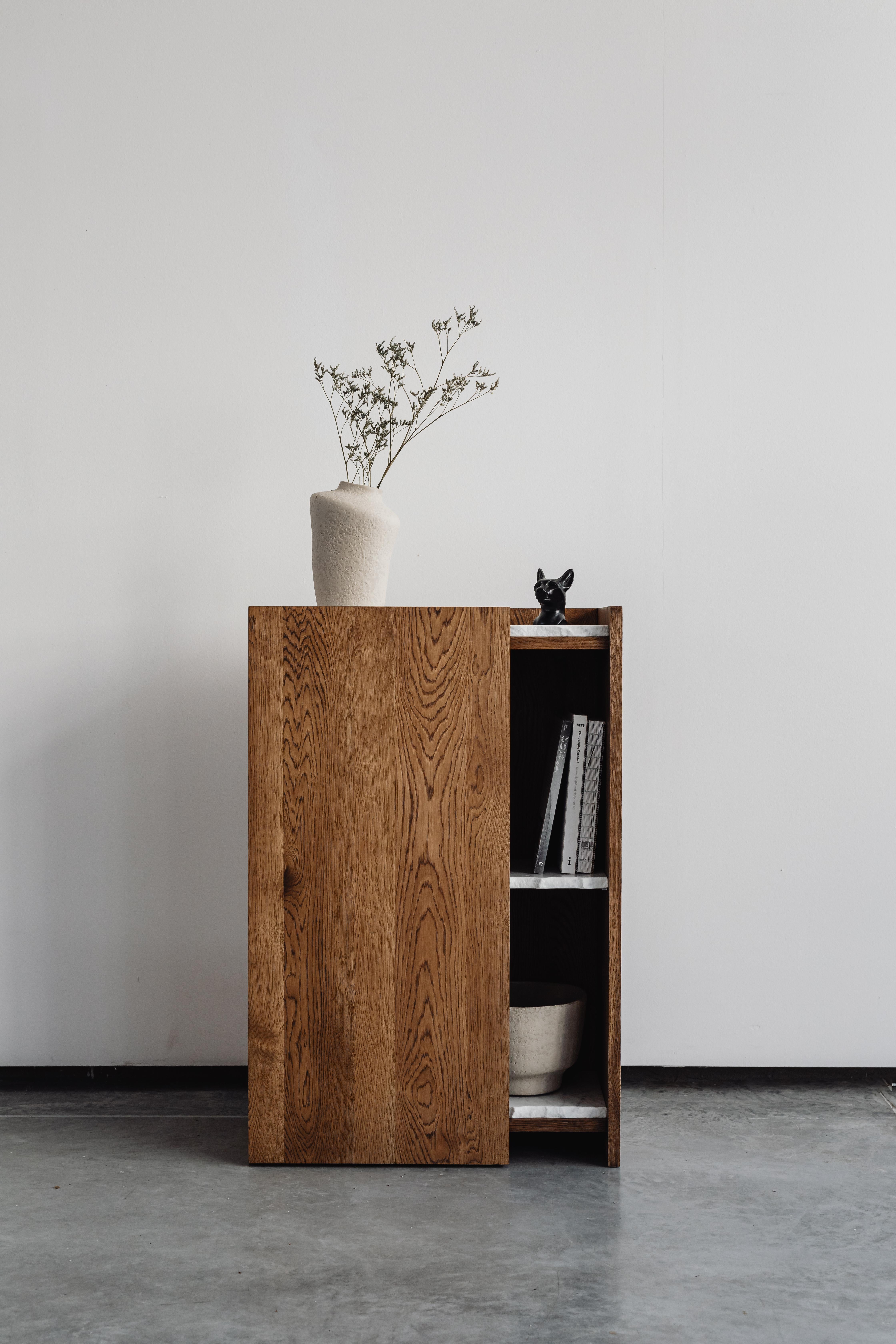 Pavo Console Table by Un’common
Designed by Małgorzata Korycka.
Dimensions: D 30 x W 60 x H 90 cm.
Materials: Carrara marble and smoky oak.

Available in different oak finishes: raw, smoky, dark, and graphite. Available in three different marble