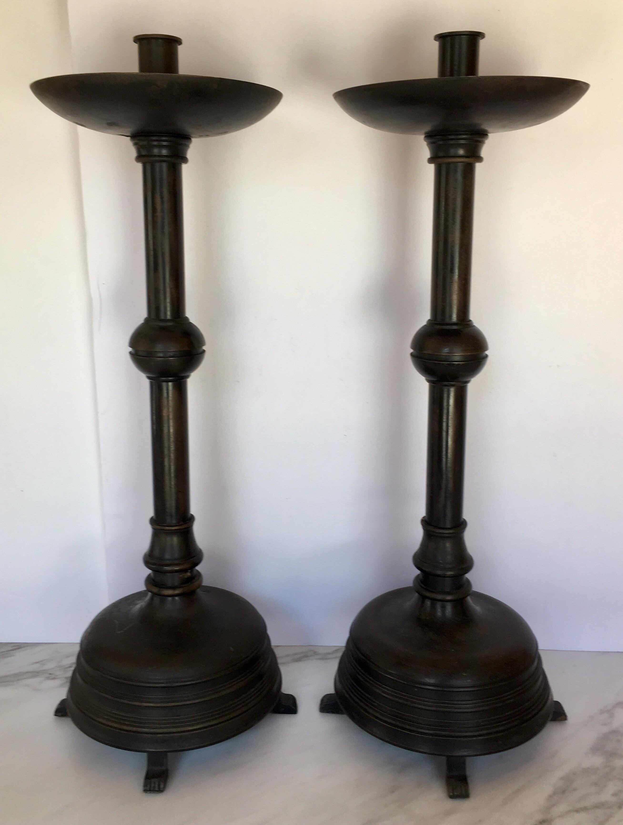 Pair of tall bronzed metal taper candlesticks with four paw-like feet.
Provenance: A private New York City Park Avenue Estate of a collector.