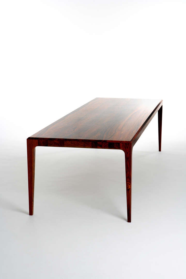 This table (measuring H73cm L292 D95cm) is made new by Paere Dansk after a design that is unattributed but possibly by Illum Wikkelso. Whilst the design stands on its own merits, the selling point of this table is the all and only solid rosewood