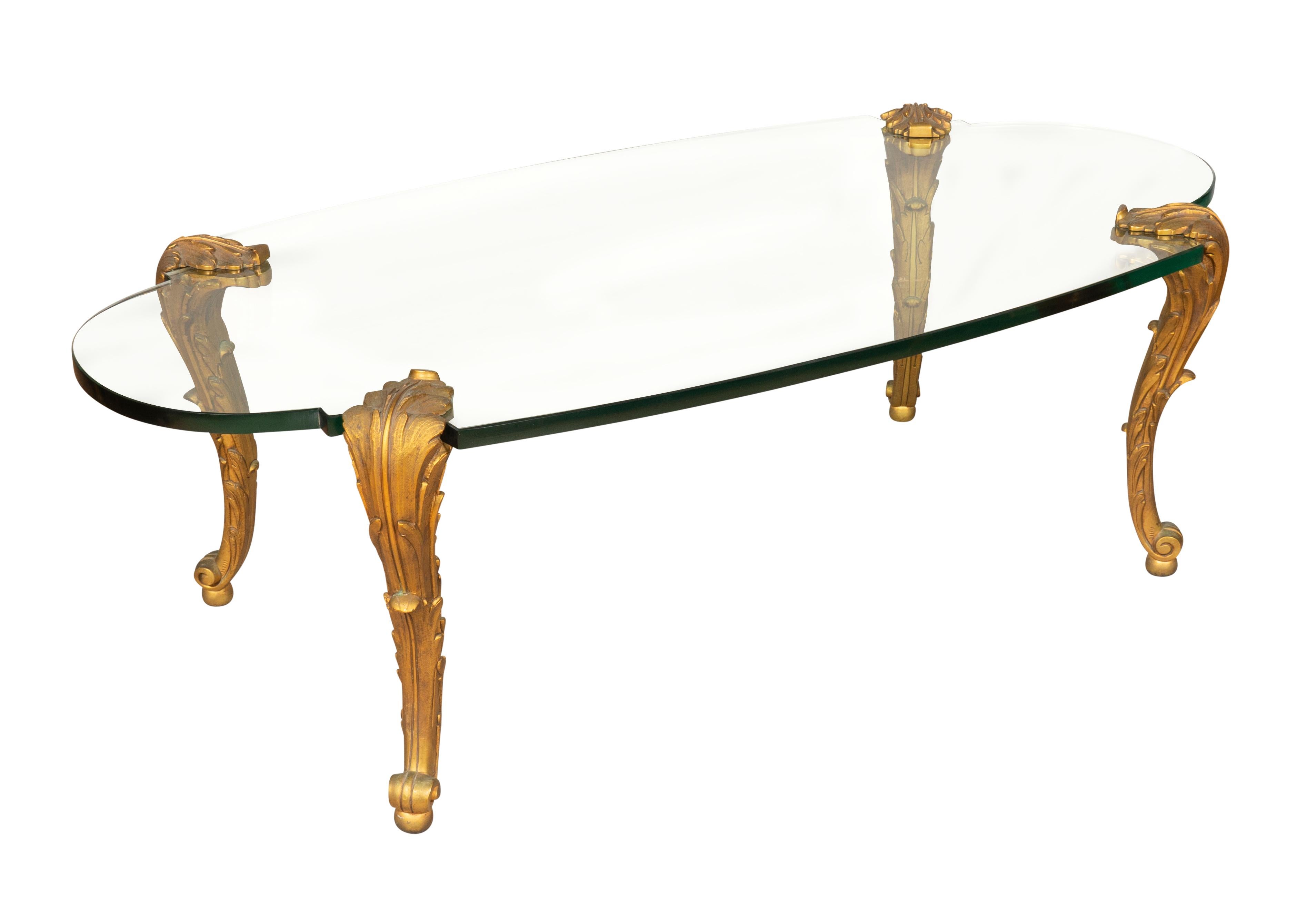 Oval shaped thick glass top supported on gilt bronze cabriole legs. Legs detach for transport. Signed P.E Guerin on underside of feet.