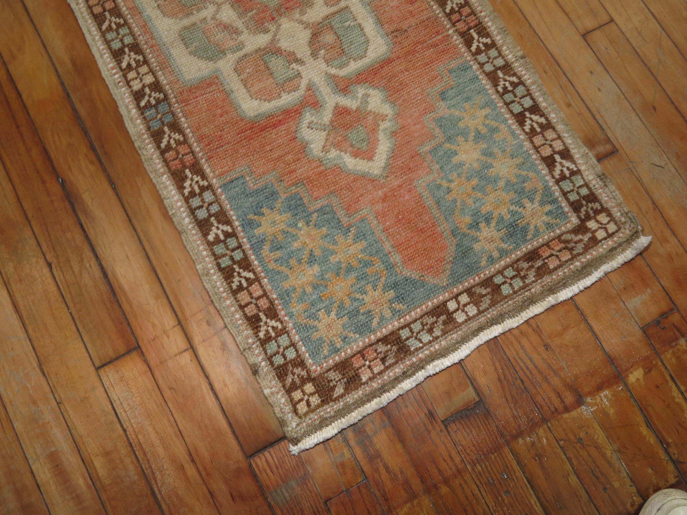 A handmade Turkish Anatolian rug in peach and green tones. Measures: 1'10