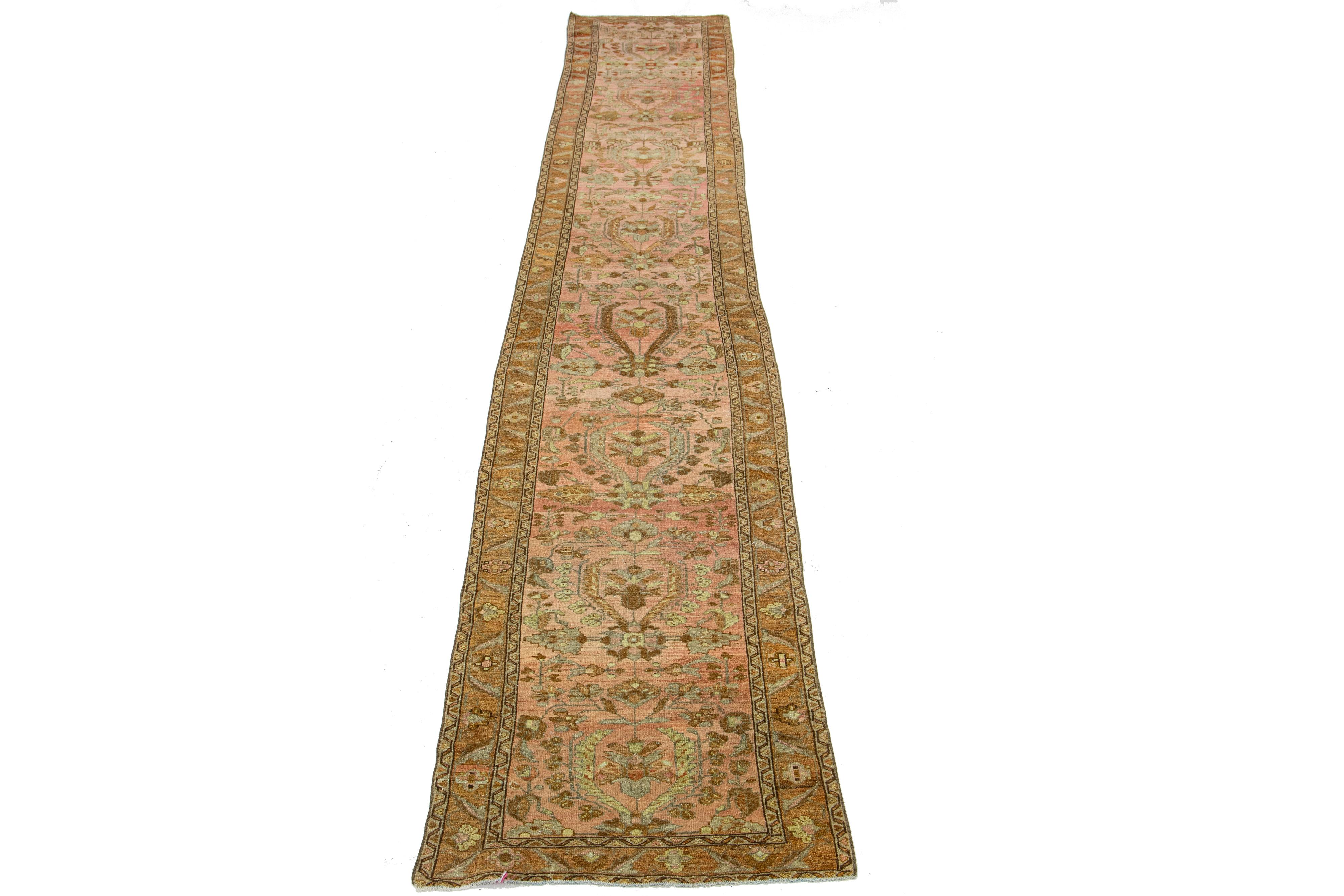 Beautiful antique Lilihan hand-knotted wool with a peach field. This Persian has blue borders with an all-over floral pattern design in brown and beige accents. 

This rug measures 2'7
