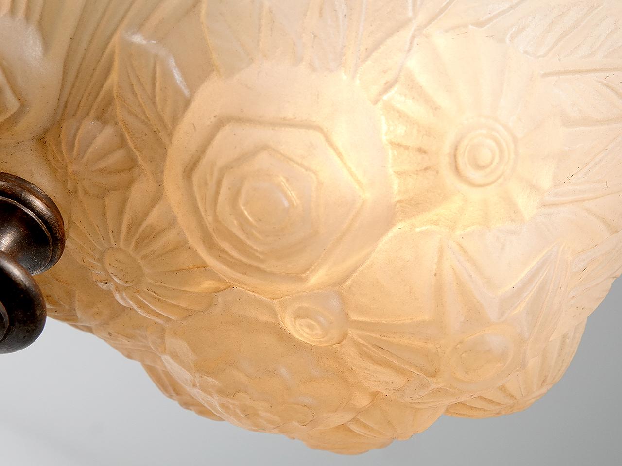 This thick cast peach lamp has the rich look and Deco style of Lalique glass. The glass is almost .5 inches thick in places. It has a rich and elegant feel and the glass color gives off a nice pleasing glow. We have a small collection of these early