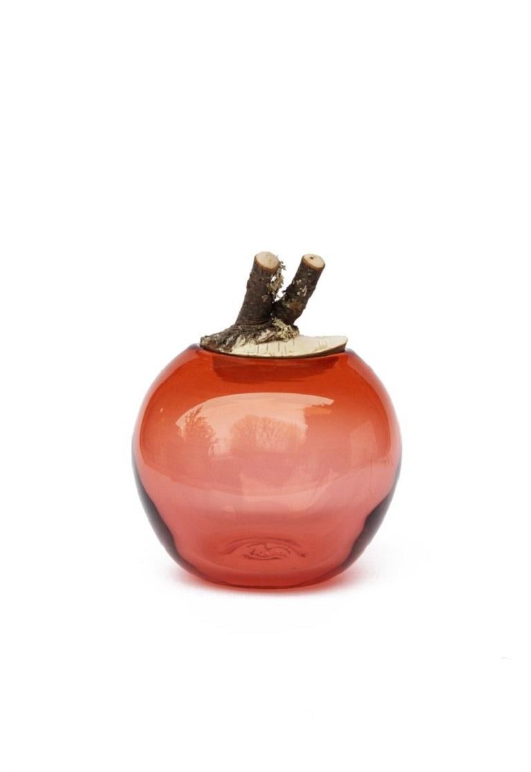Peach double branch bowl, Pia Wüstenberg
Dimensions: D 16-18 x H 20.
Materials: glass, wood.
Available in other colors.

A playful jar, with a lid made from a branch stub following the curvature of the glass. Branch Bowls are blown without a