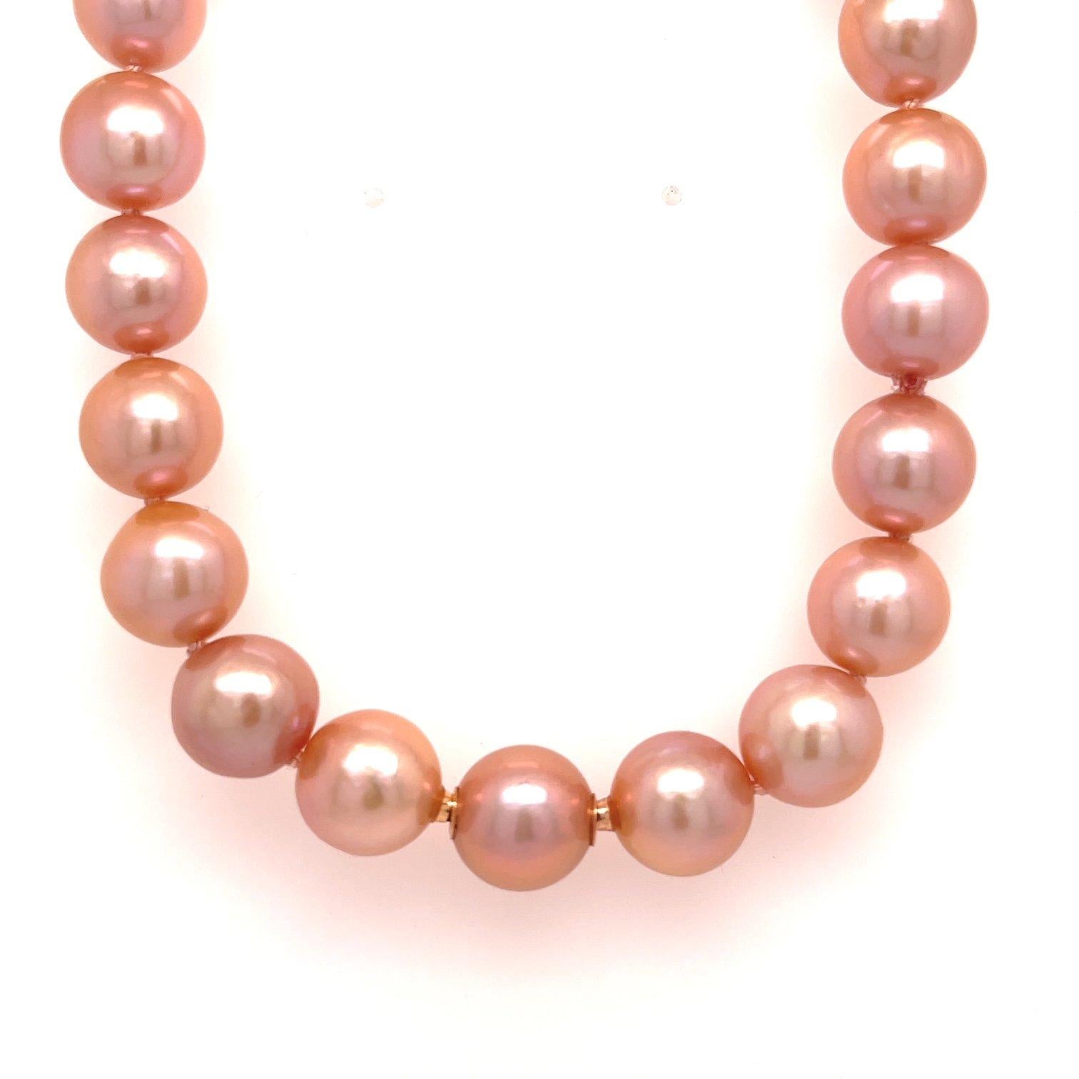 A strand of peach fresh water pearls, 10mm-11mm, cultured from Yangtze China, with 18k rose gold modullyn parts.  And a brown and white druzy heart clasp in 18k rose gold set with a .59ctw brown rose cut pear shape diamond. Includes a peach fresh