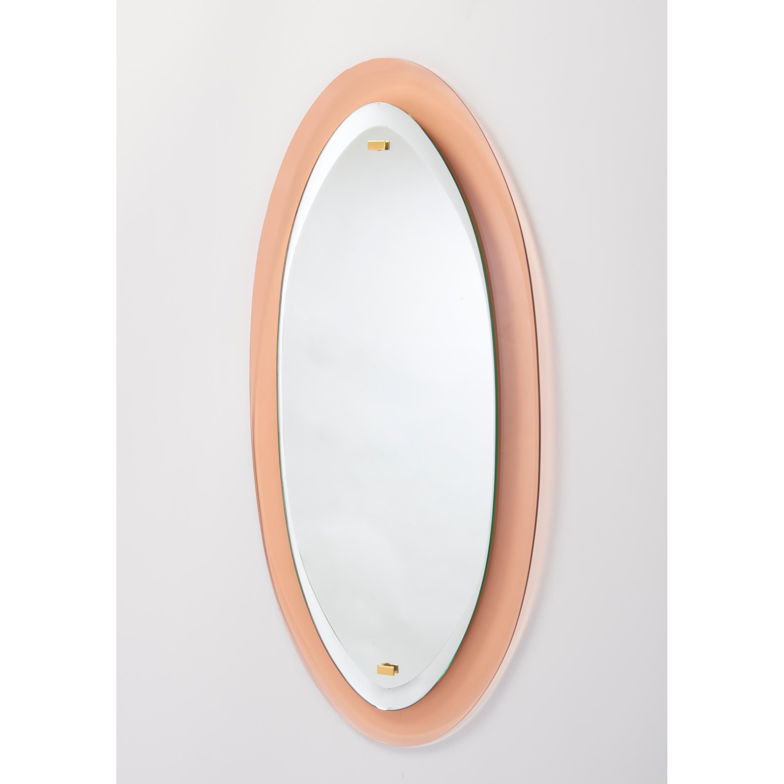 Italy, 1960's
An oval mirror on beveled colored glass frame, with polished brass mounts
Dimensions : 35 H x 17 W.