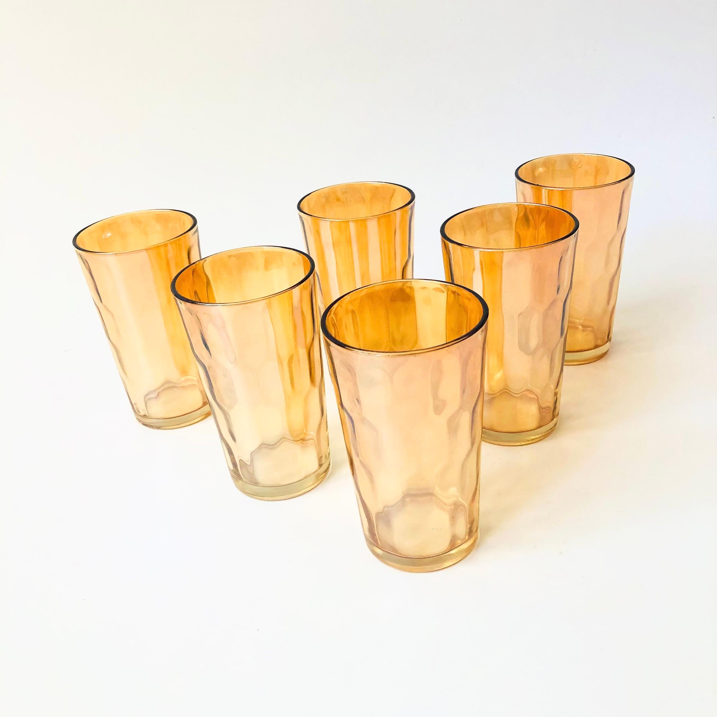 A set of 6 vintage tumblers tall tumblers. Beautiful peach luster color to the slightly textured glass. Perfect for using as water glasses or for cocktails.

